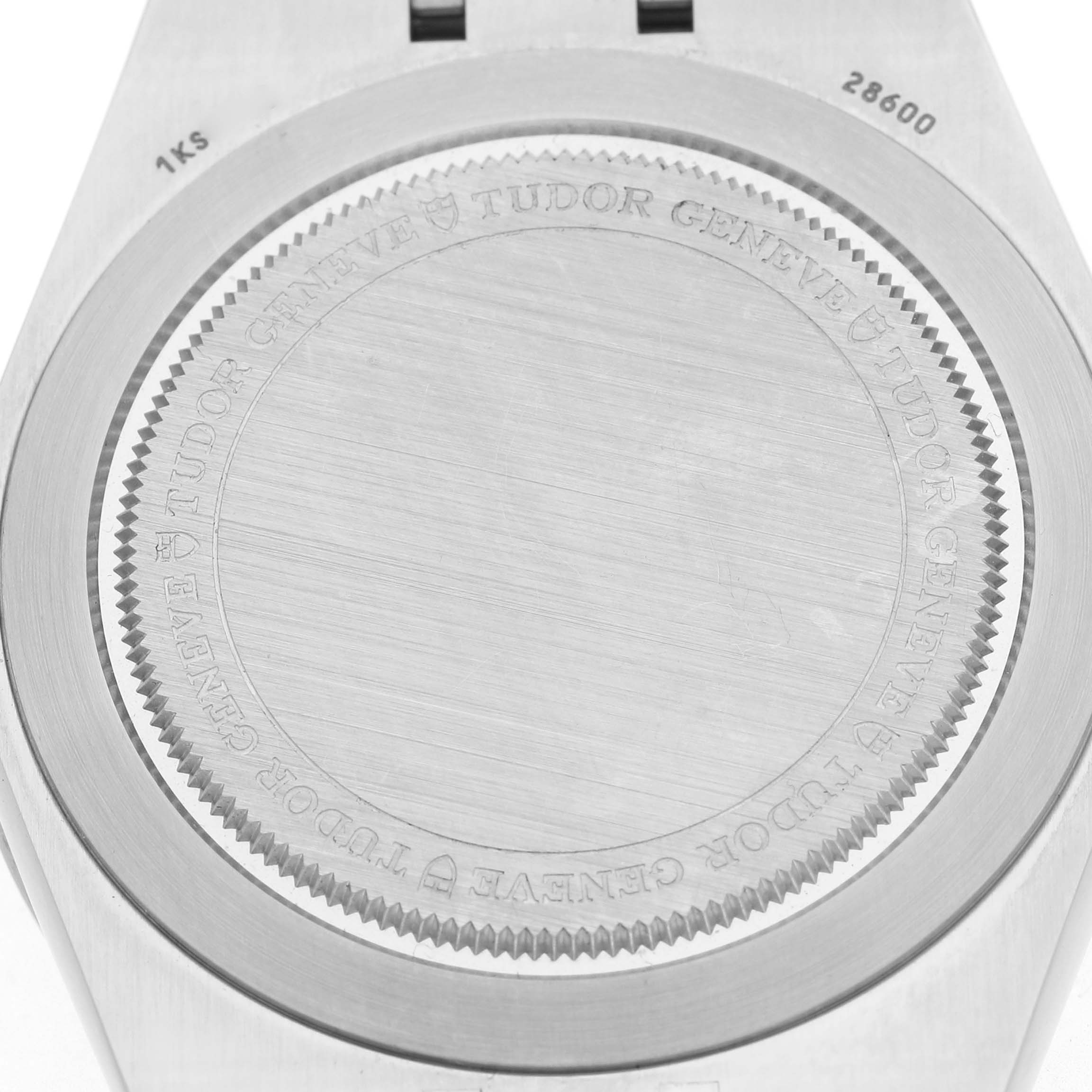 The image shows the back case of a Tudor Royal 28600-0003 Men's Stainless Steel Black Dial watch, displaying the engraved brand name and a brushed metal finish.