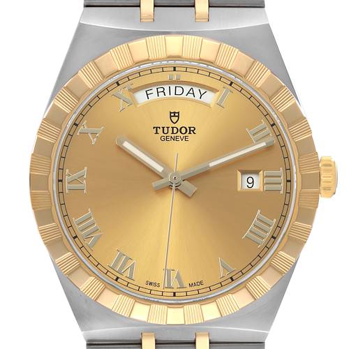 The Tudor Royal 28603 Men's Stainless Steel Champagne Dial watch is shown from the front, displaying its gold dial, day-date features, and Roman numerals.