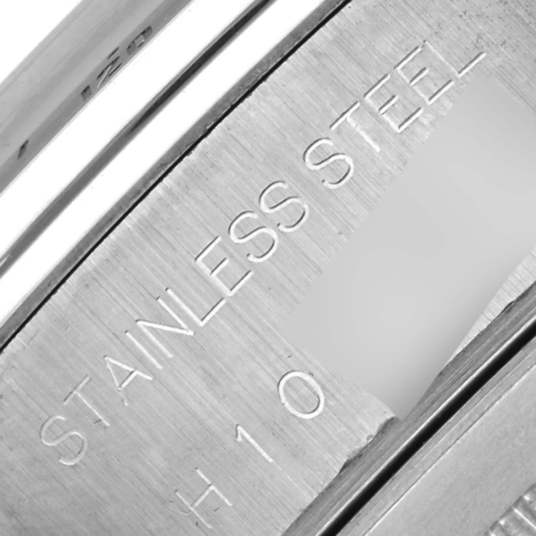 The image shows a close-up of the stainless steel back of a Tudor Tiger 79280P Men's Stainless Steel Red Dial 79280P Men's Stainless Steel Red Dial watch, emphasizing the engraved text.