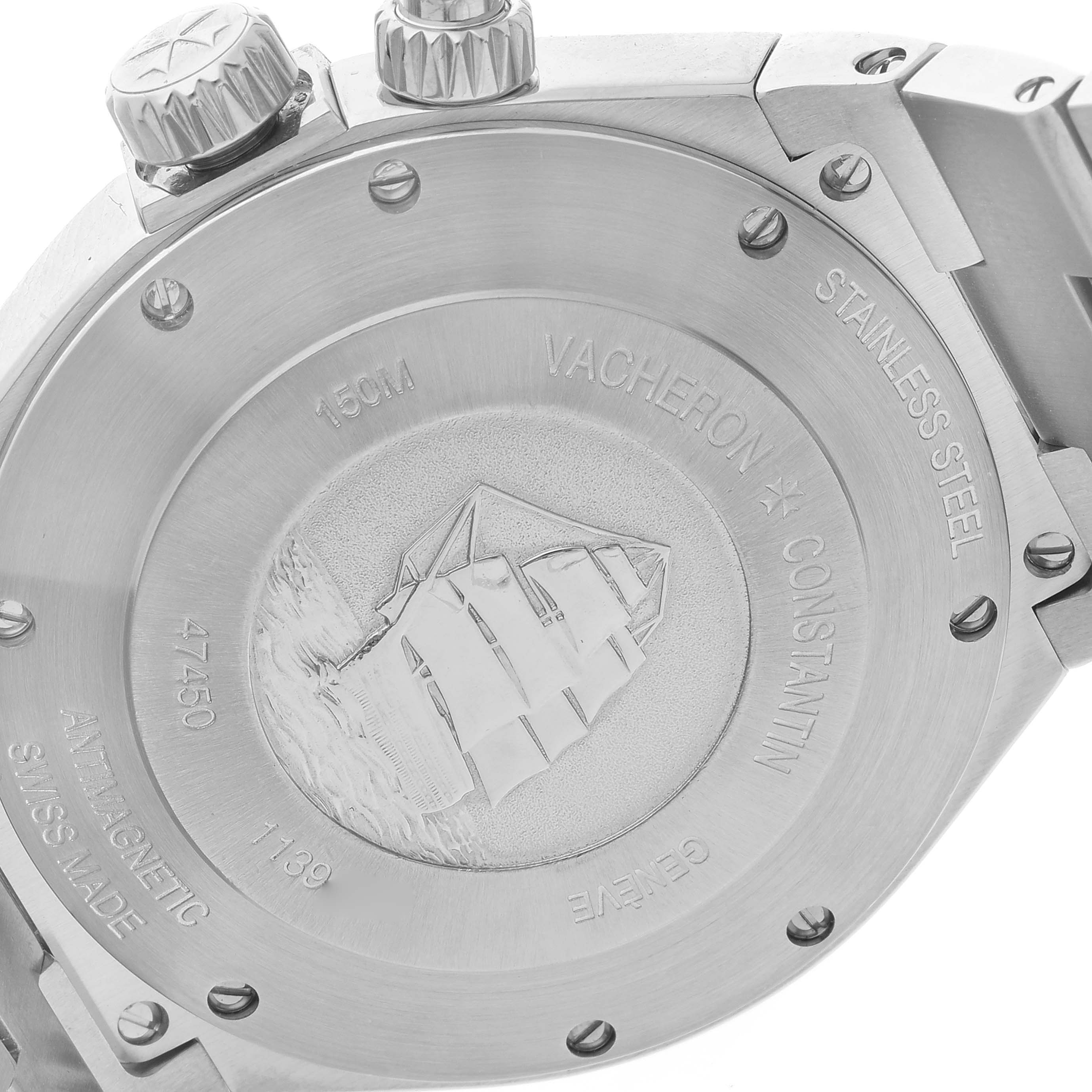 The image shows the back case of the Vacheron Constantin Overseas 47450/B01A Men's Stainless Steel Black Dial 47450/B01A Men's Stainless Steel Black Dial watch, highlighting the engraved details and crown.