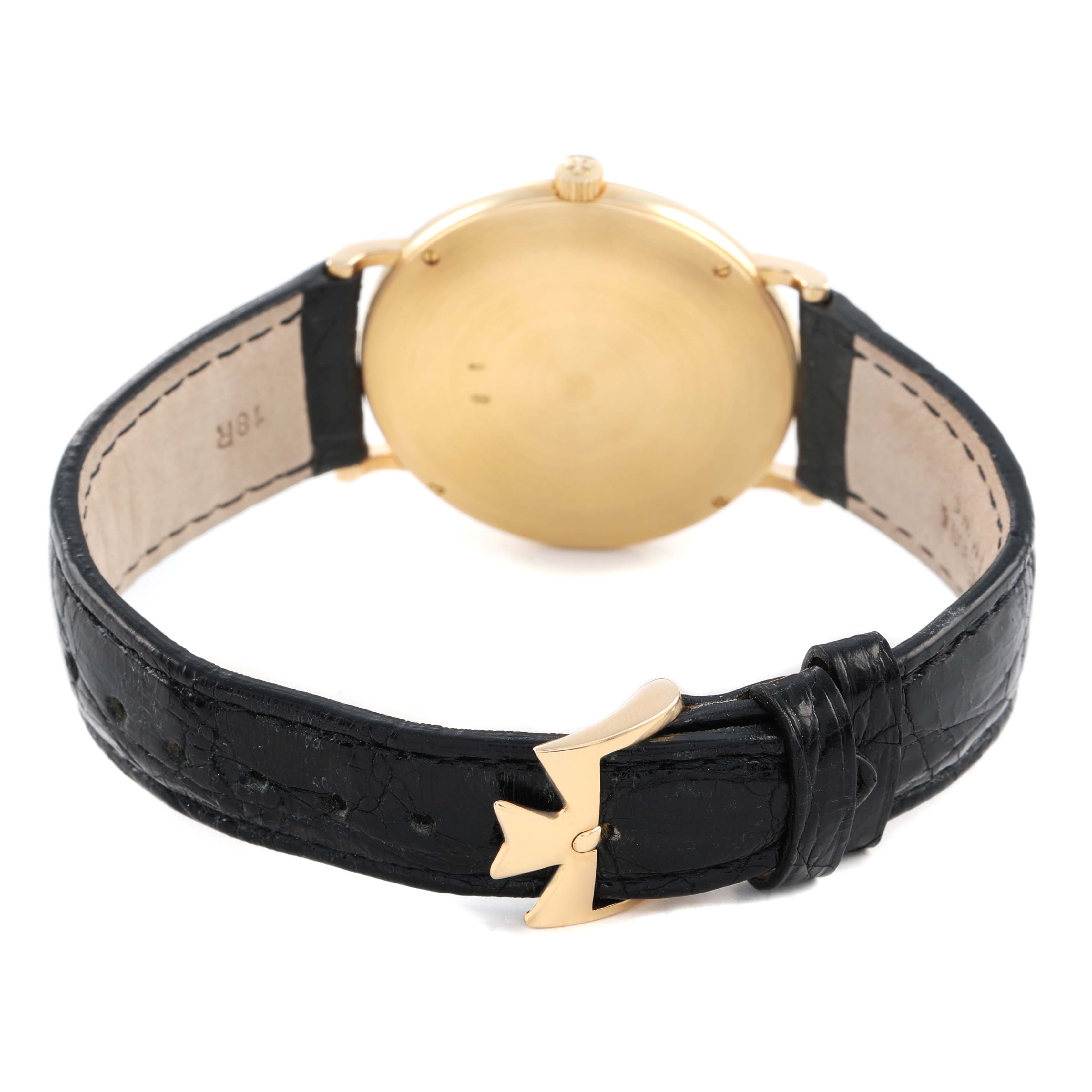 The image shows the back of a Vacheron Constantin Patrimony 92238 Men's Yellow Gold Champagne Dial watch, highlighting the case and black leather strap with a gold buckle.