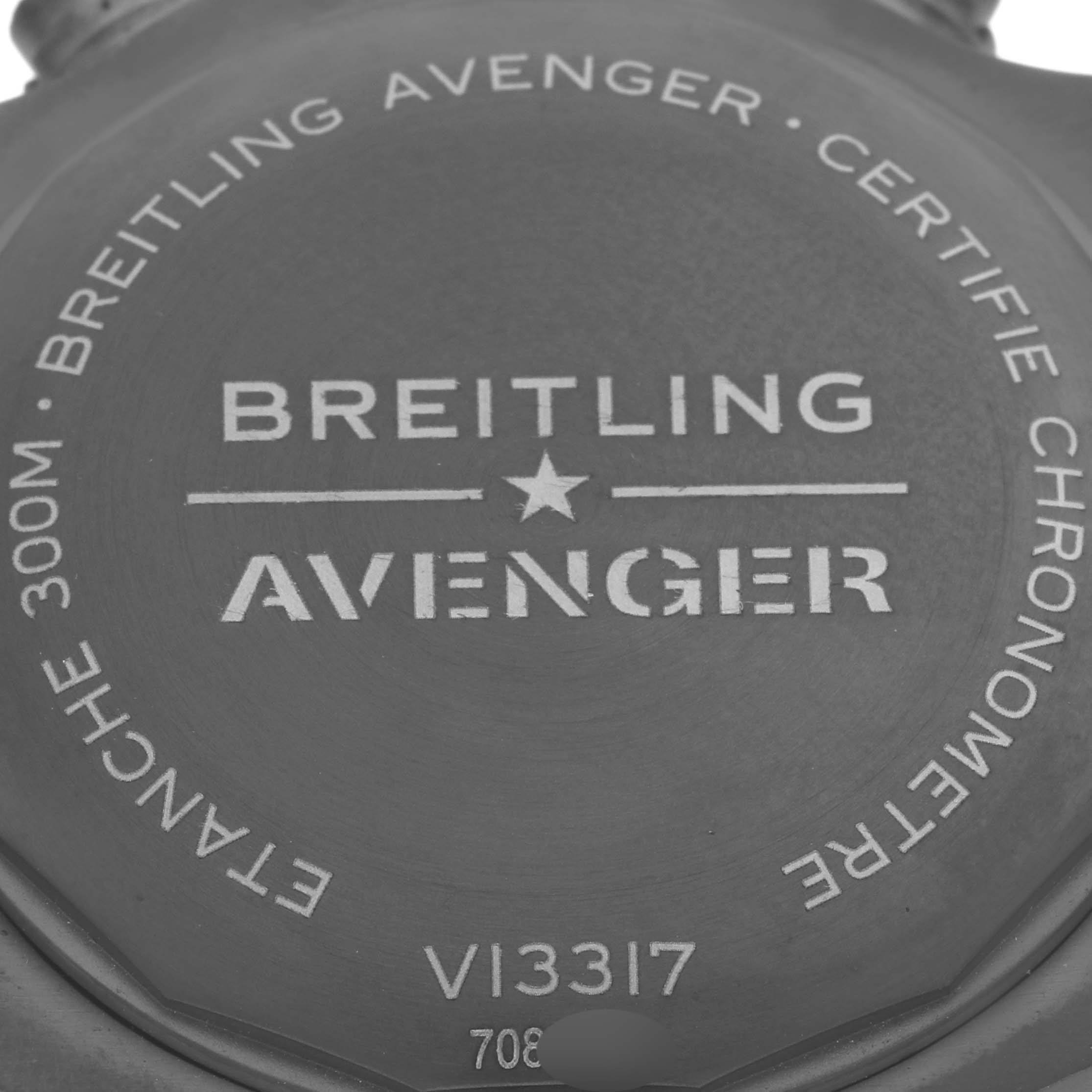 The image shows the case back of a Breitling Avenger V13317 Men's Titanium Black Dial V13317 Men's Titanium Black Dial watch, highlighting branding and specifications.