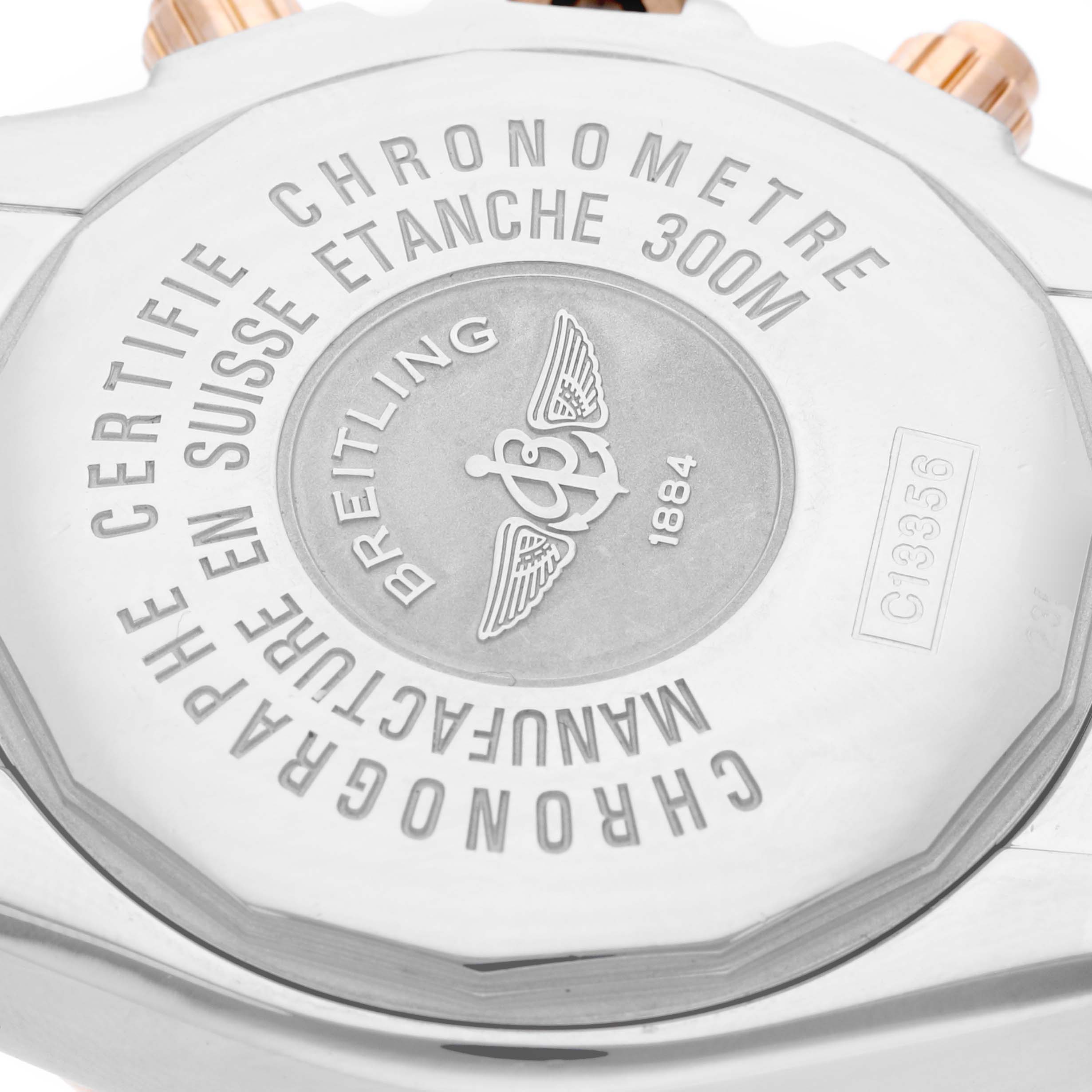 The image shows the back view of a Breitling Chronomat C1335653/B821 Men's Steel and Gold (two tone) Black Dial C1335653/B821 Men's Steel and Gold (two tone) Black Dial watch, highlighting the engravings and logo.