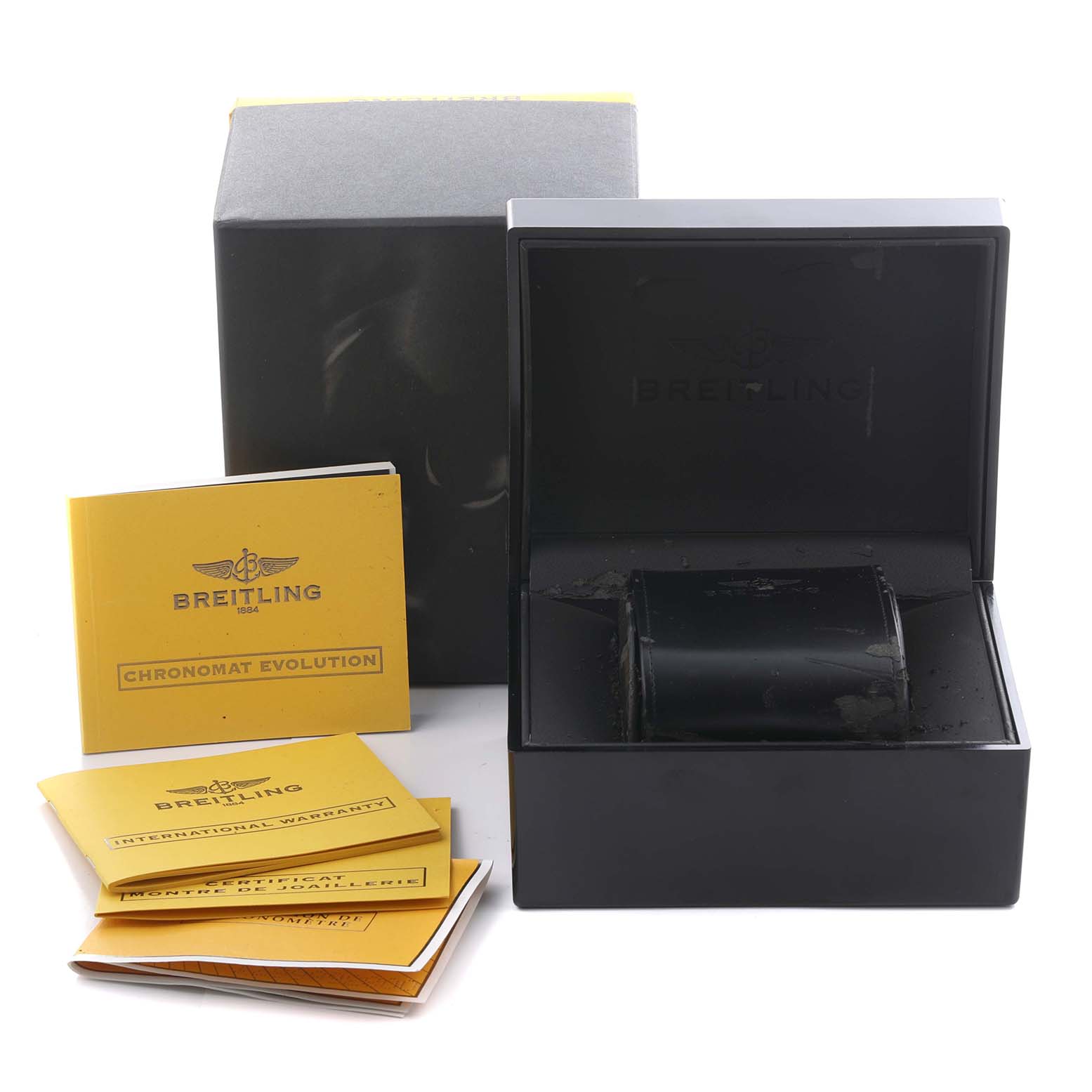 The Breitling Chronomat C1335653/B821 Men's Steel and Gold (two tone) Black Dial C1335653/B821 Men's Steel and Gold (two tone) Black Dial packaging includes an open box, outer box, and several yellow instruction manuals from a front angle.