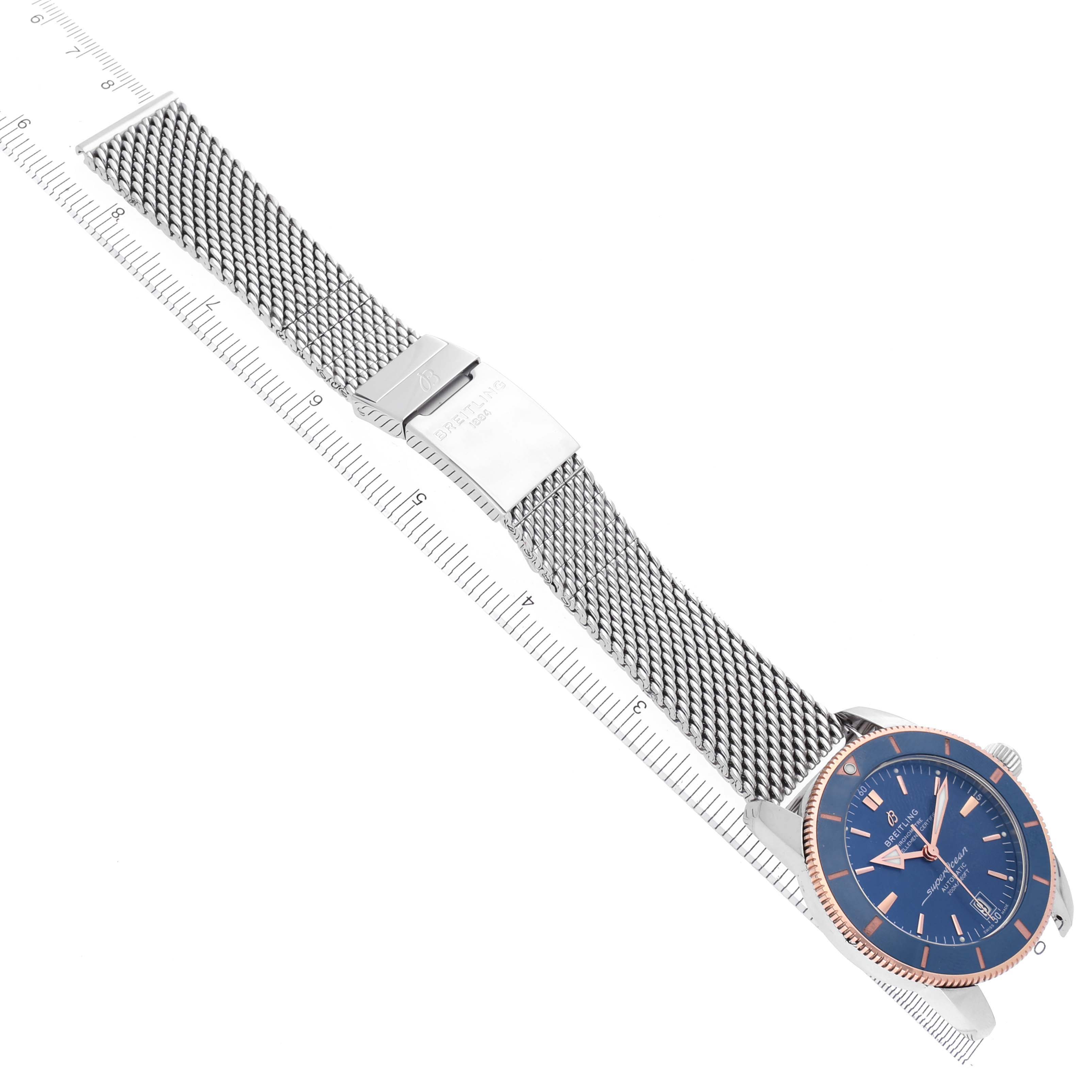 The image shows a Breitling Superocean UB2010161C1A1 Men's Stainless Steel Blue Dial UB2010161C1A1 Men's Stainless Steel Blue Dial watch at a diagonal angle, highlighting its mesh strap and blue dial.