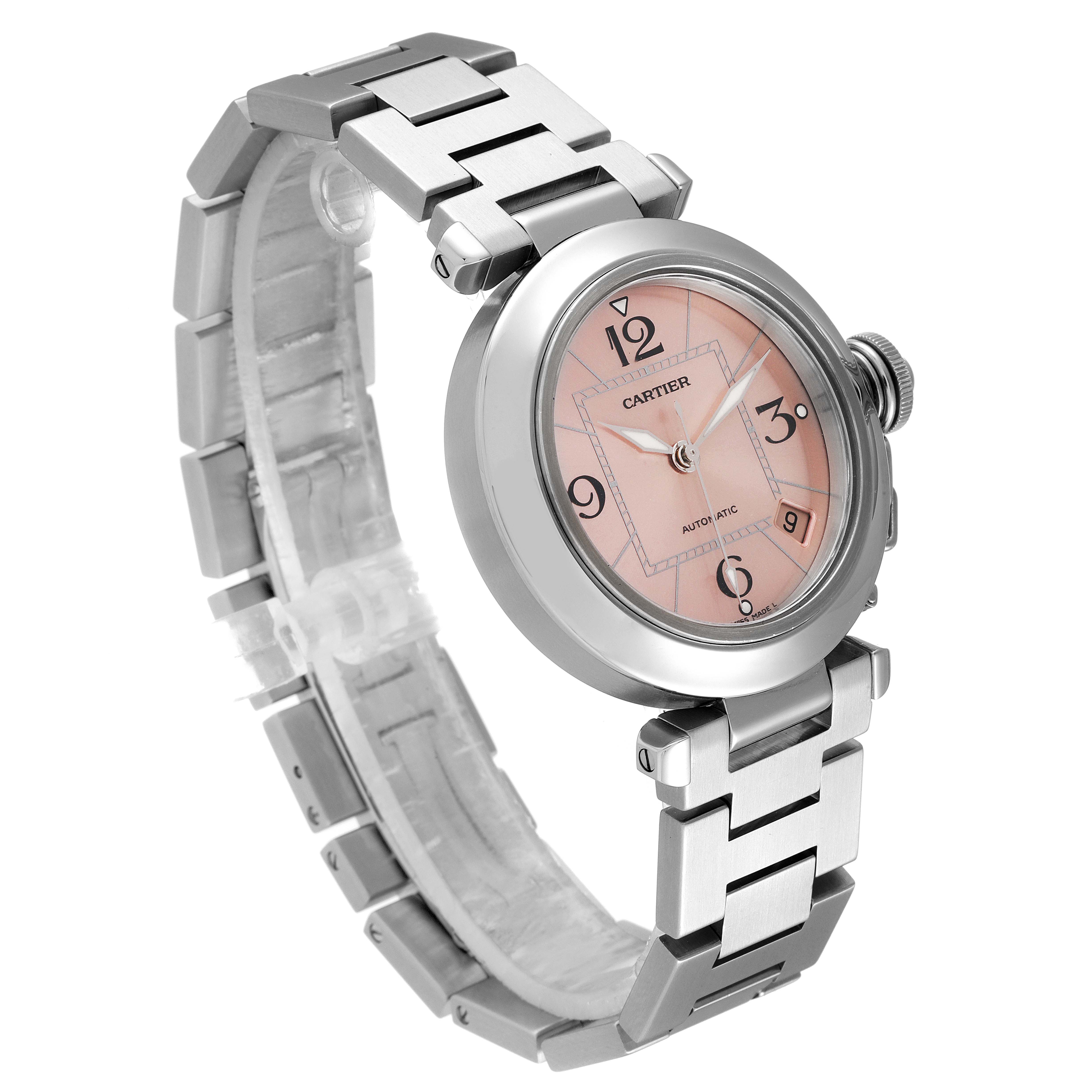 The image shows an angled view of a Cartier Pasha W31075M7 Women's Stainless Steel Pink Dial W31075M7 Women's Stainless Steel Pink Dial watch, highlighting the face, bezel, and metal bracelet.