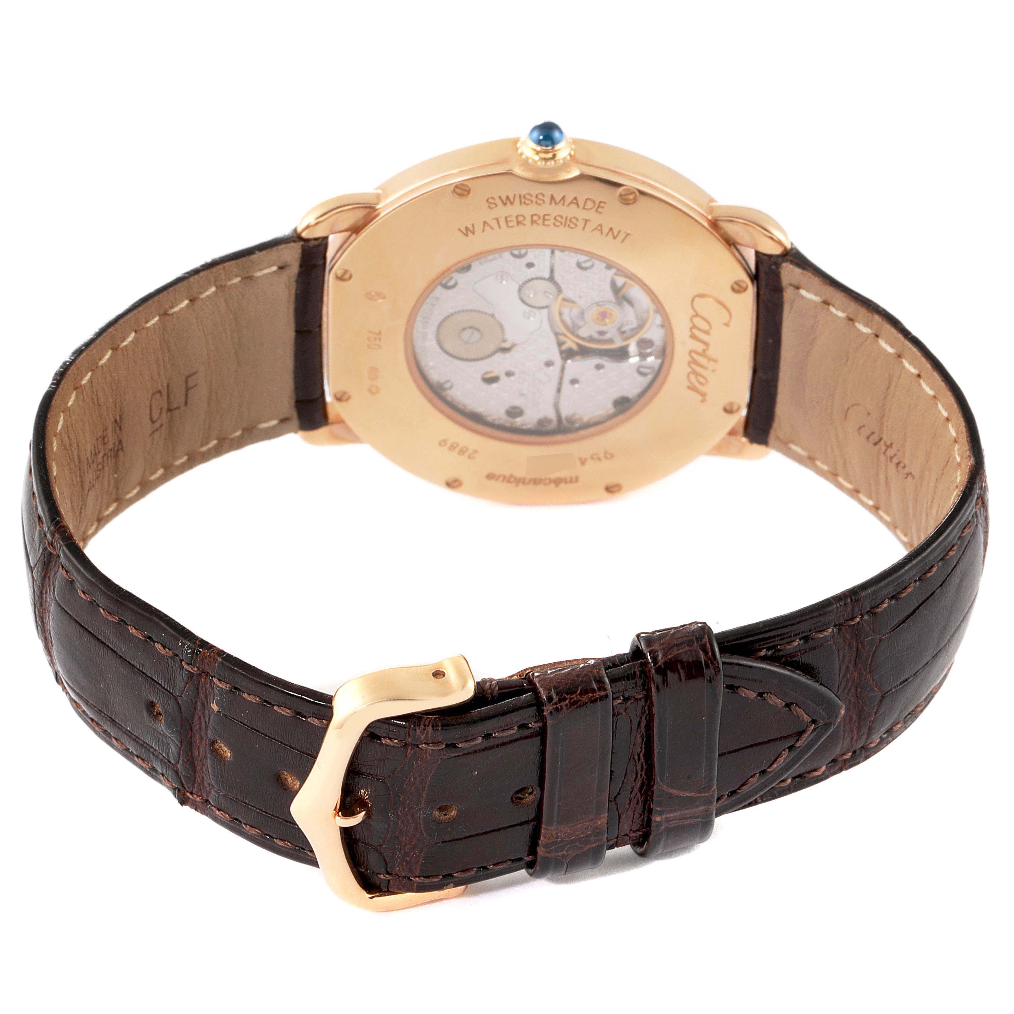 The Ronde model by Cartier is shown from the back, highlighting its transparent case back and leather strap with a buckle.