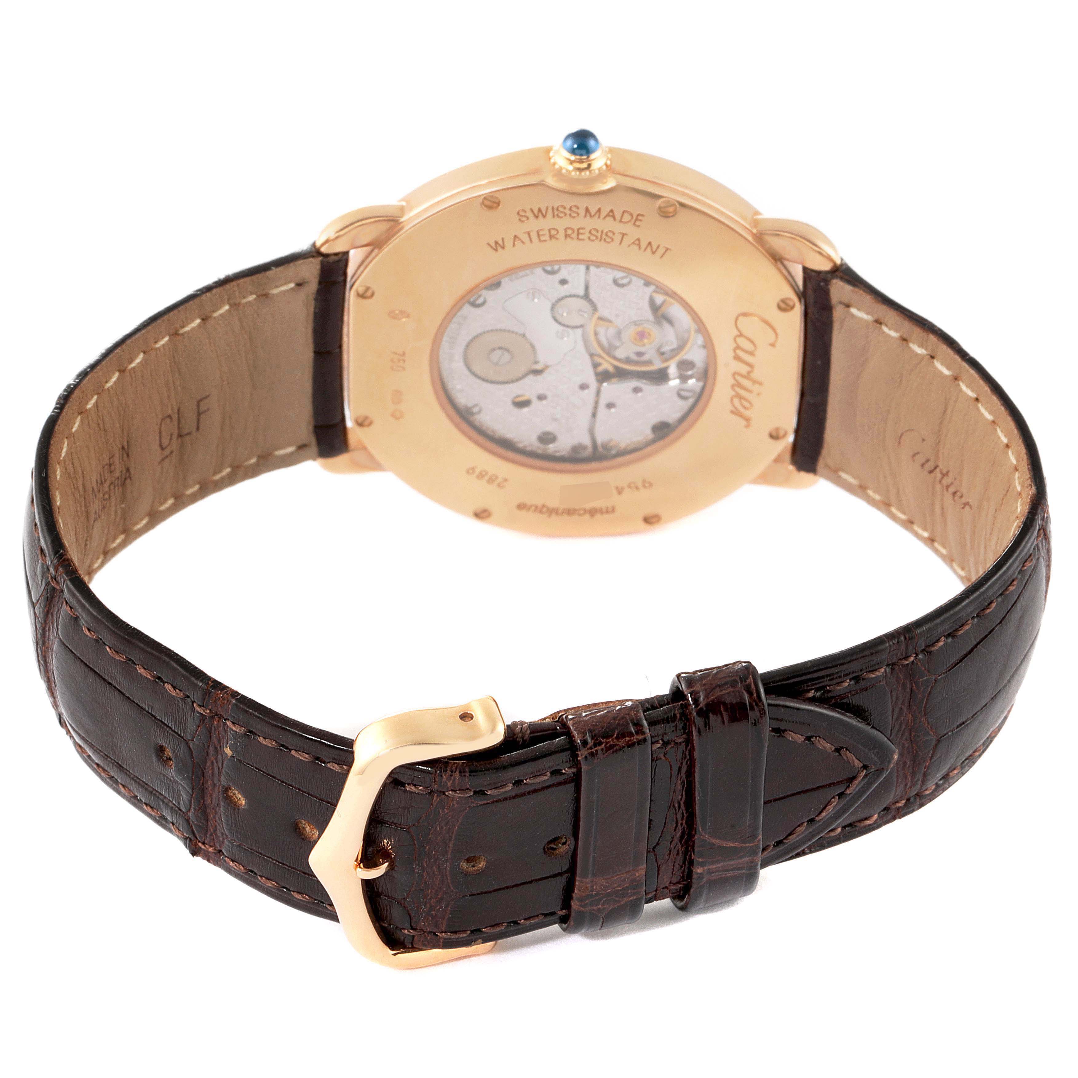 The image shows the back view of a Cartier Ronde W6800251 Men's Rose Gold Silver Dial watch, highlighting its exposed mechanism and brown leather strap with a gold buckle.