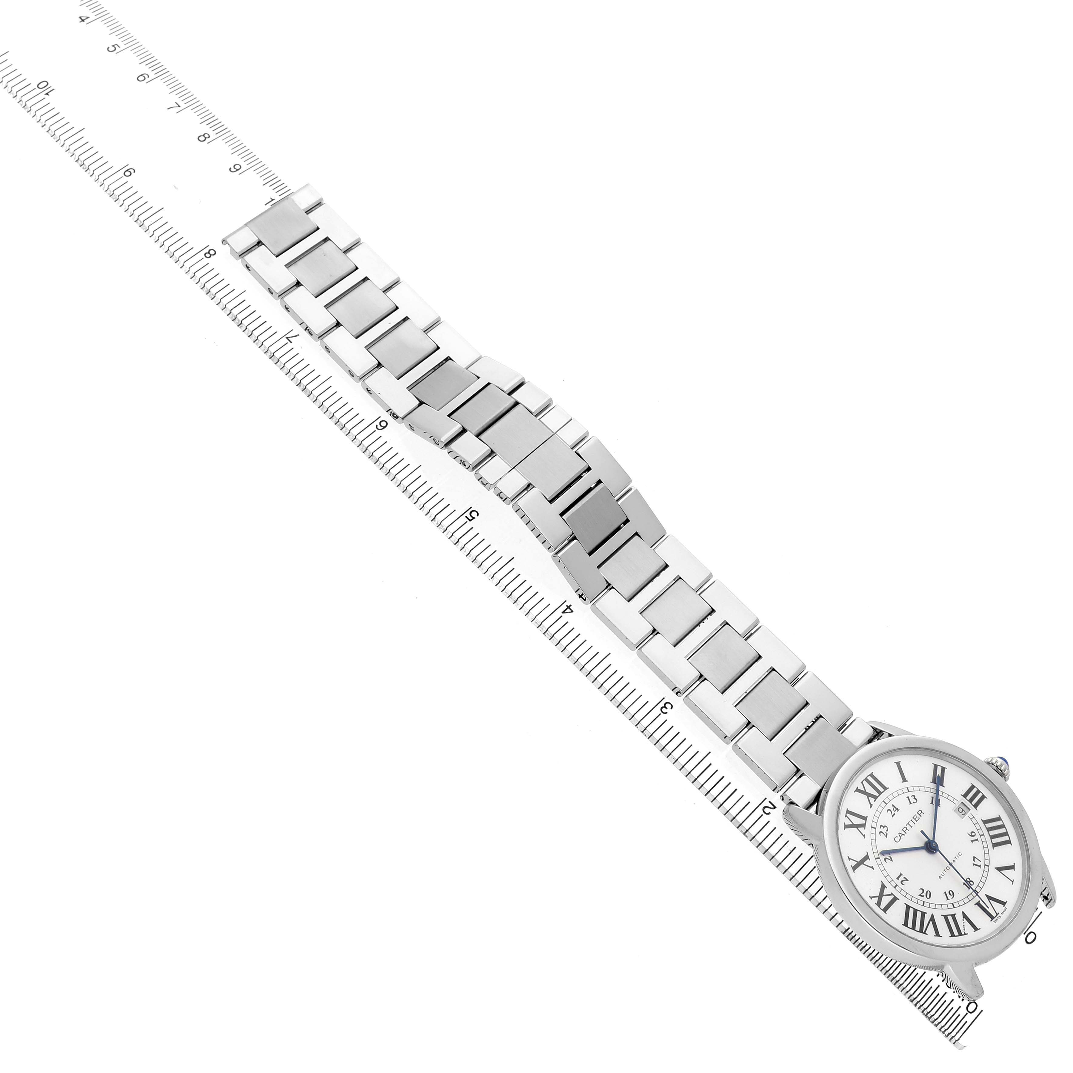 The Cartier Ronde W6701011 Men's Stainless Steel Silver Dial watch is shown from a top view with its face and full metal bracelet visible, alongside a ruler for scale.