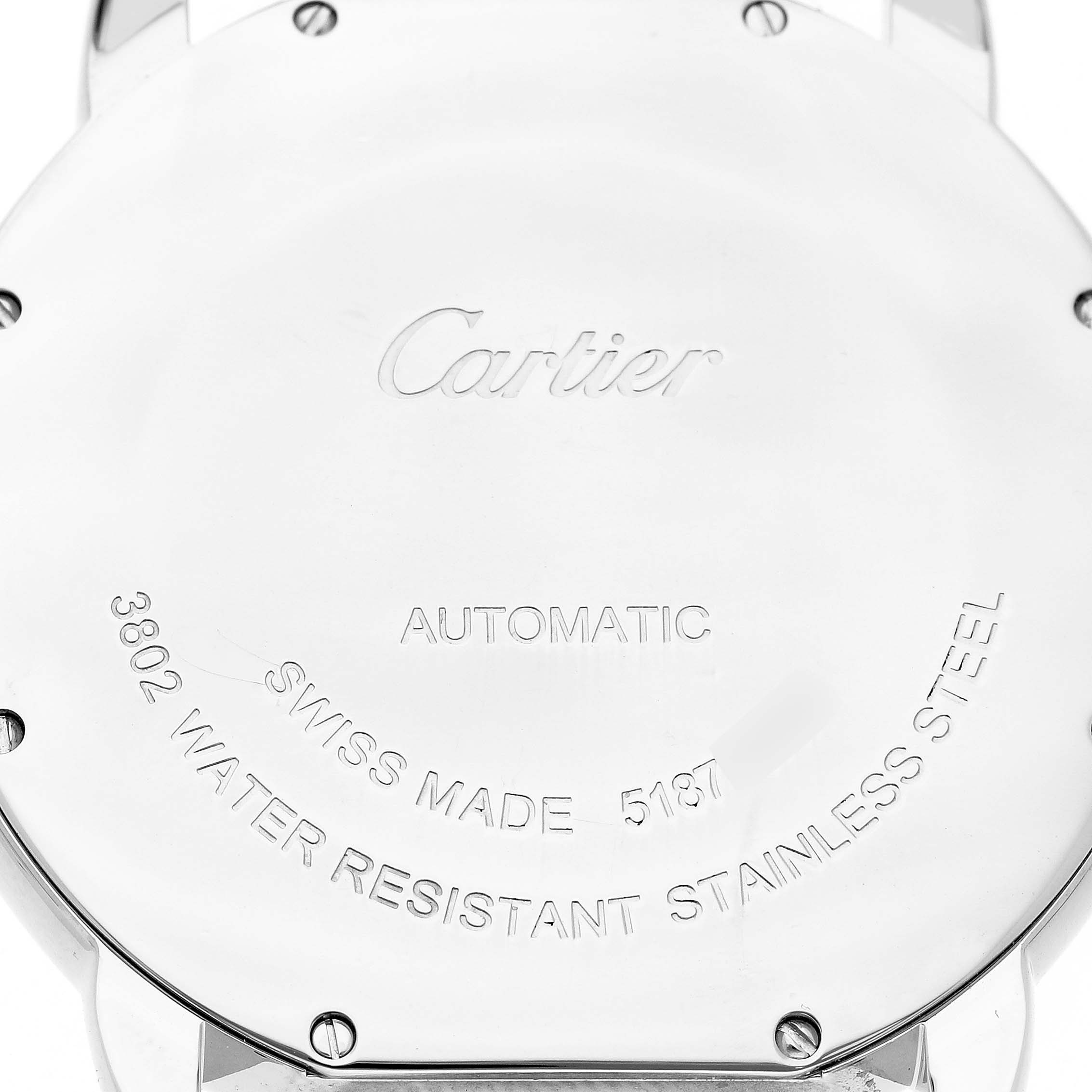 The image shows the back case of a Cartier Ronde W6701011 Men's Stainless Steel Silver Dial watch, highlighting engravings and screws.