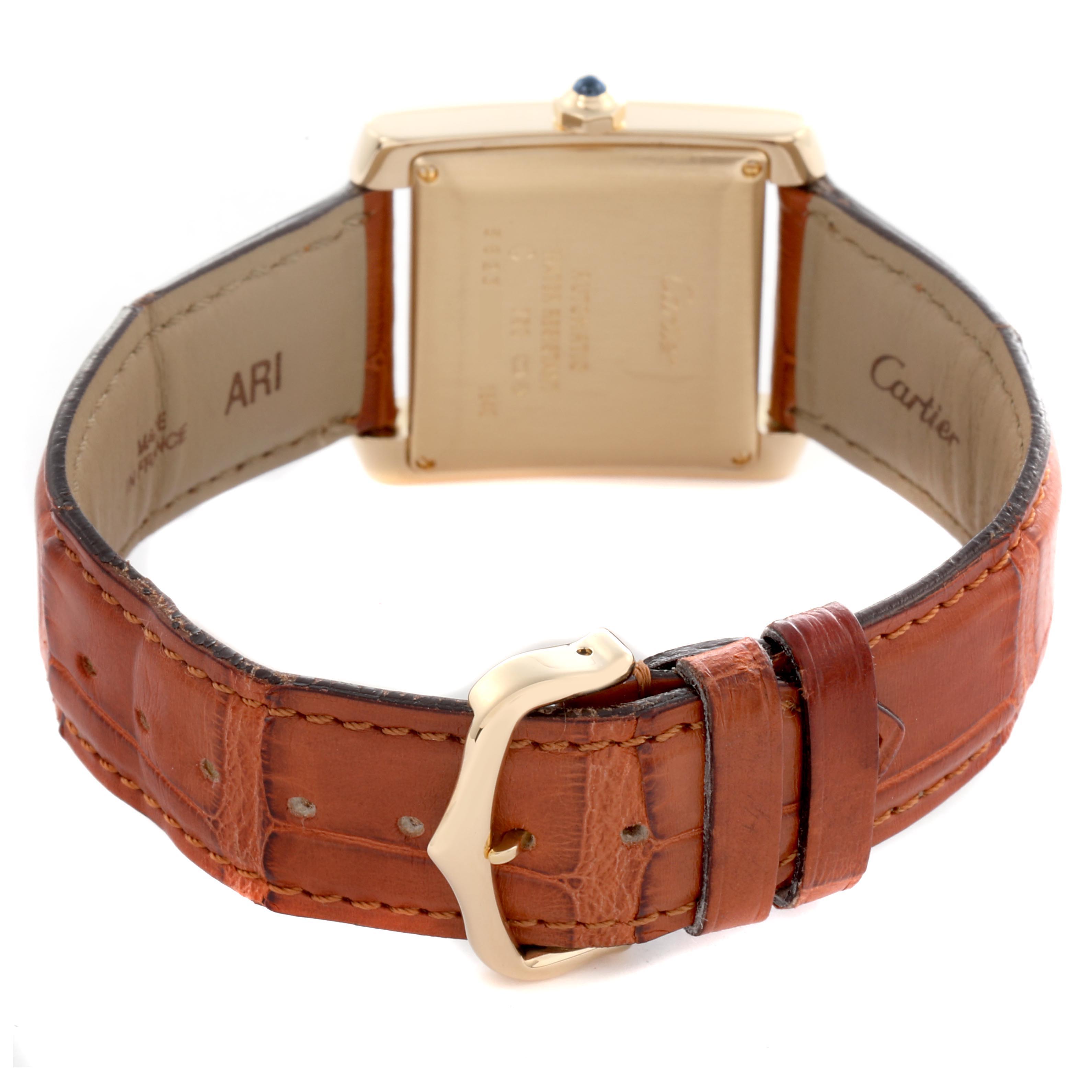 The image shows the back of a Cartier Tank Française watch with a brown leather strap and gold buckle.