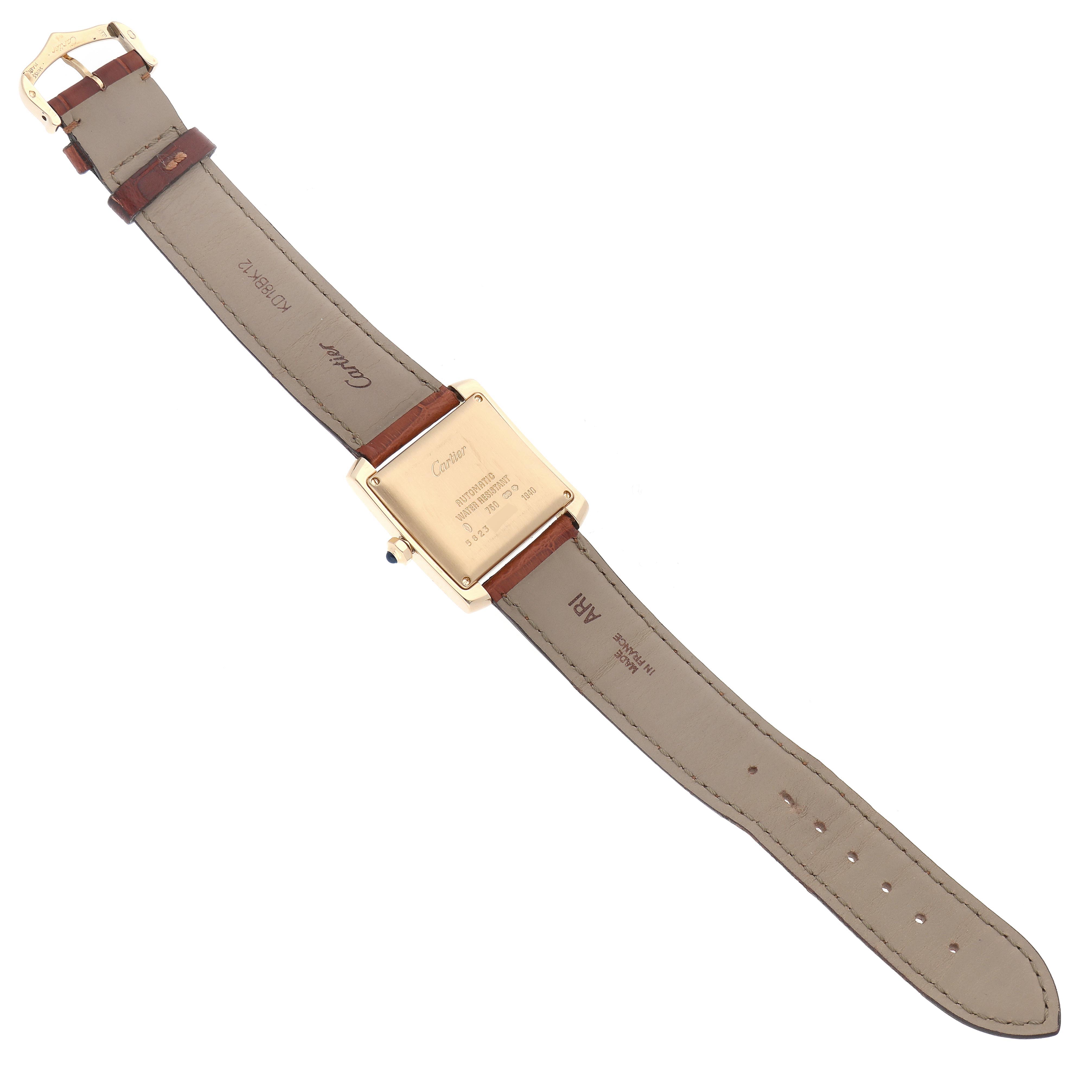 The Cartier Tank Française watch is shown from the back, highlighting its case and leather strap with visible markings.