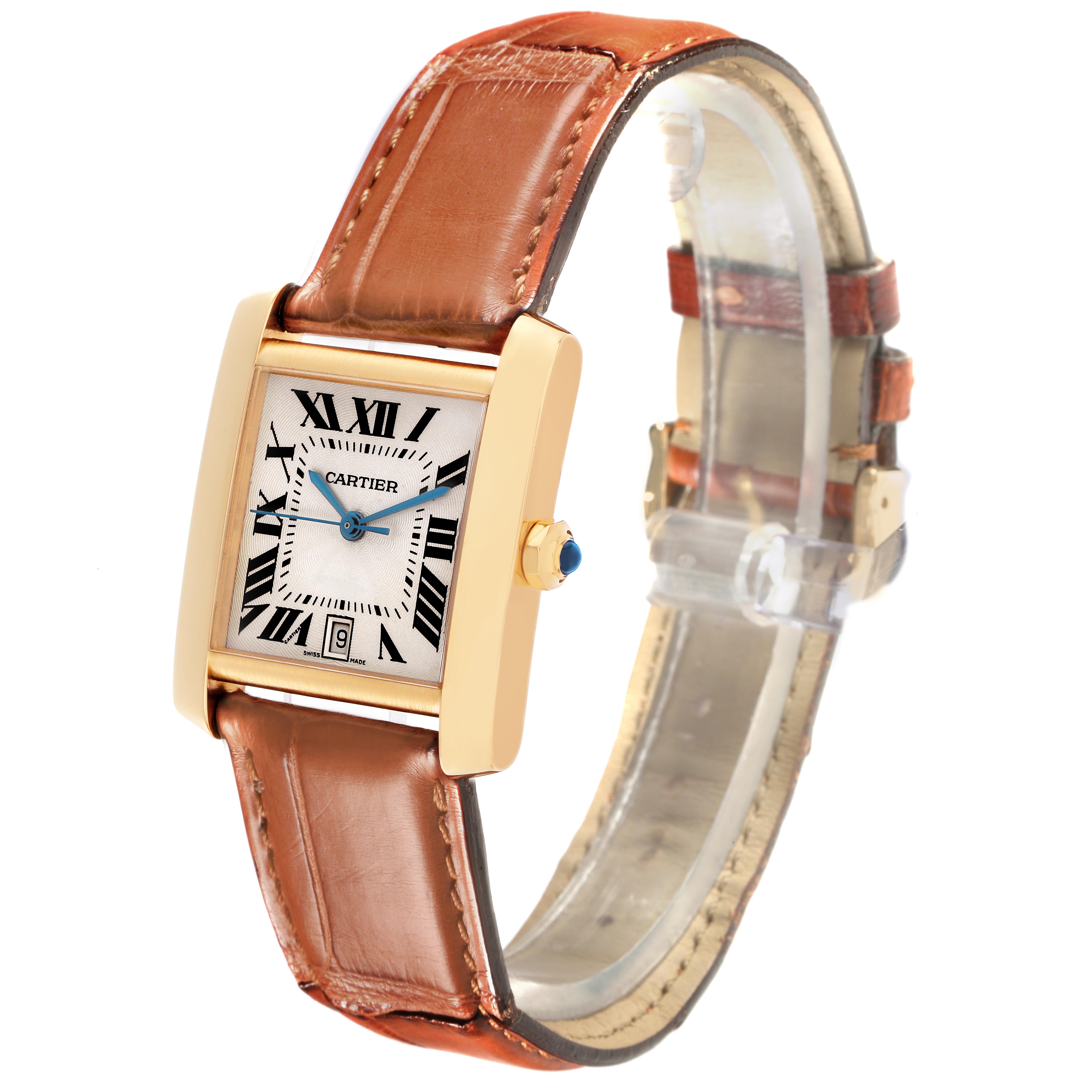 The Cartier Tank Française watch is shown at an angle displaying the face, crown, and brown leather strap.