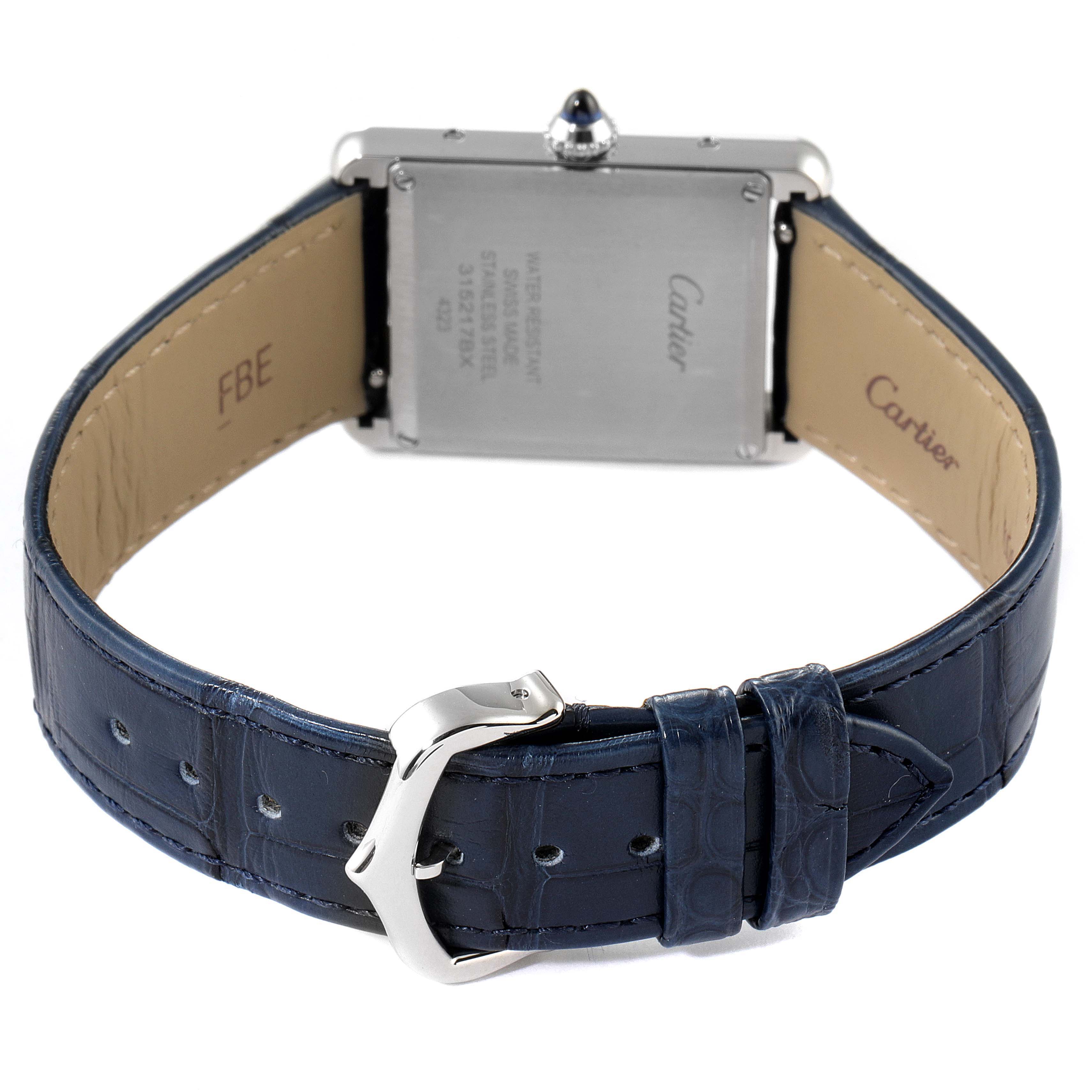 The image shows the back of a Cartier Tank Must WSTA0055 Women's Stainless Steel Blue Dial WSTA0055 Women's Stainless Steel Blue Dial watch, highlighting the case, blue strap, and clasp.