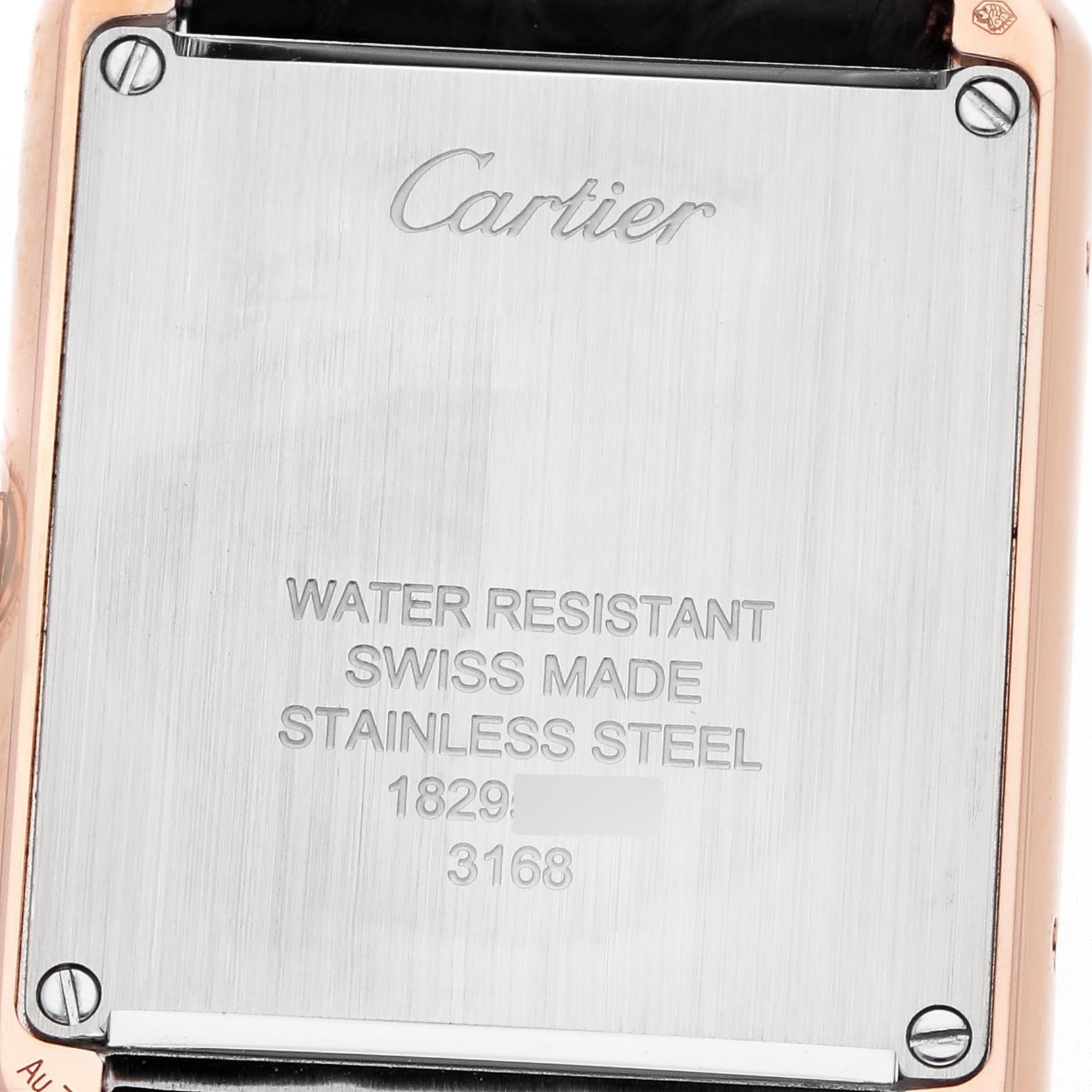 The image shows the stainless steel case back of the Cartier Tank Solo W5200024 Women's Steel and Gold (two tone) Silver Dial W5200024 Women's Steel and Gold (two tone) Silver Dial watch, highlighting the brand engraving and specifications.