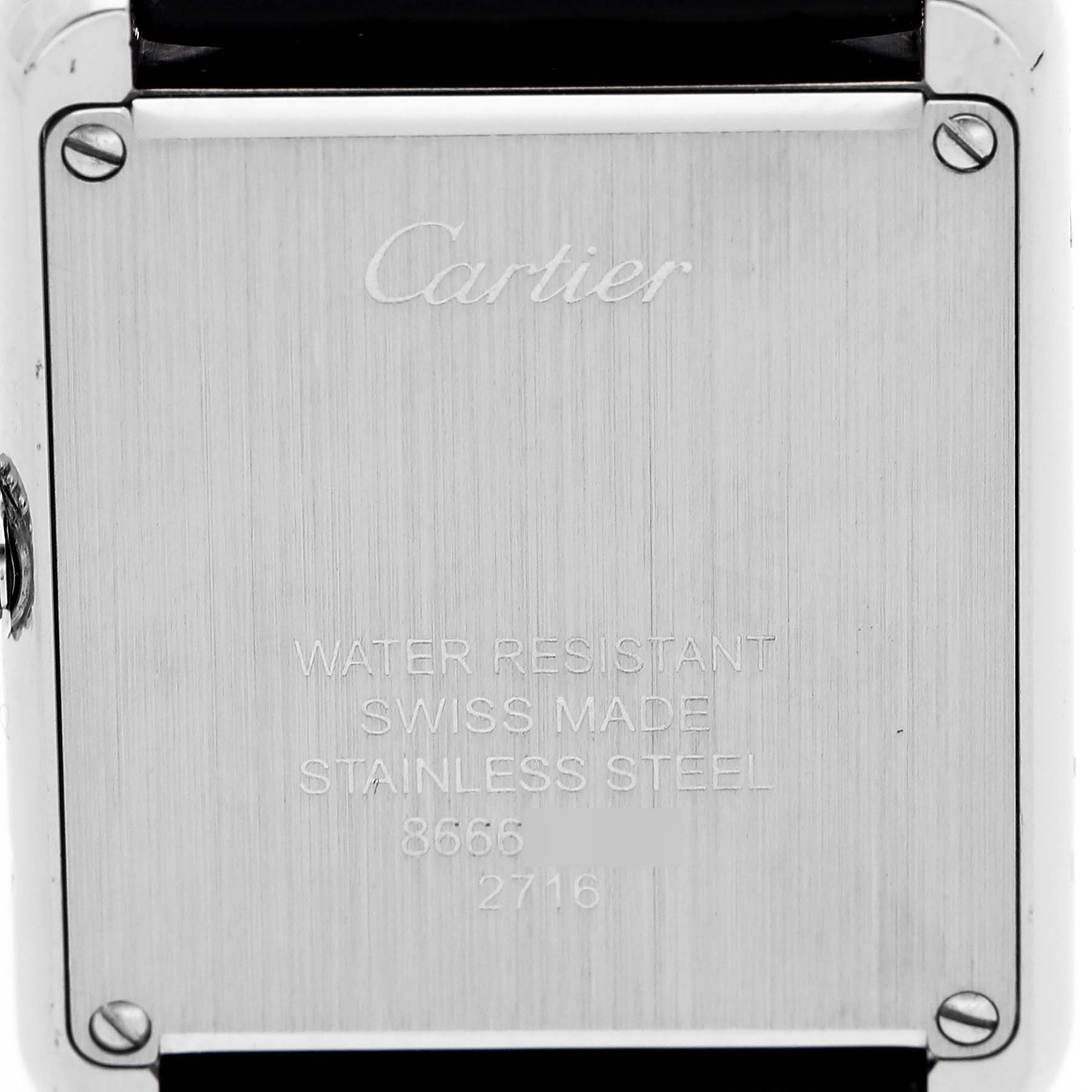 The image shows the back case of a Cartier Tank Solo W1018255 Women's Stainless Steel Silver Dial watch, highlighting engravings and screws.
