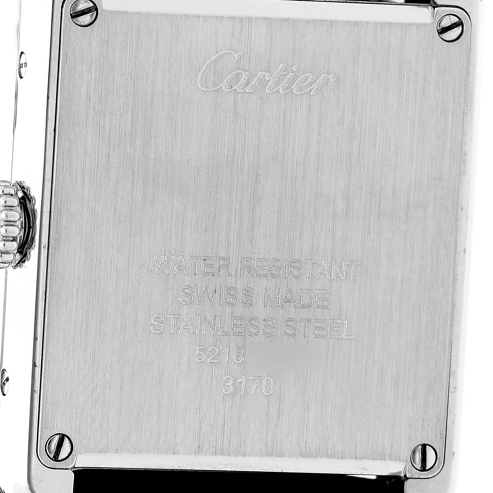 The image shows the back case of a Cartier Tank Solo W5200005 Women's Stainless Steel Silver Dial watch, featuring engraved details and screws.