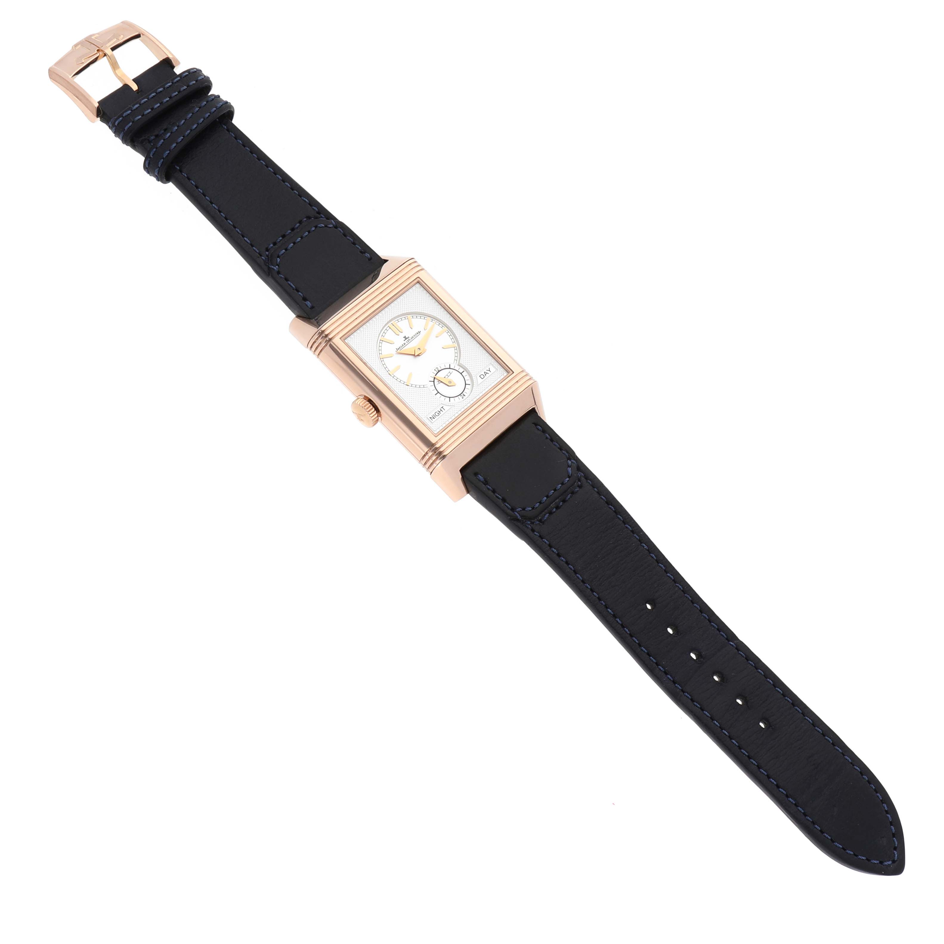 The image shows a top-down view of the Jaeger-LeCoultre Reverso watch, displaying its dial, case, crown, and leather strap.