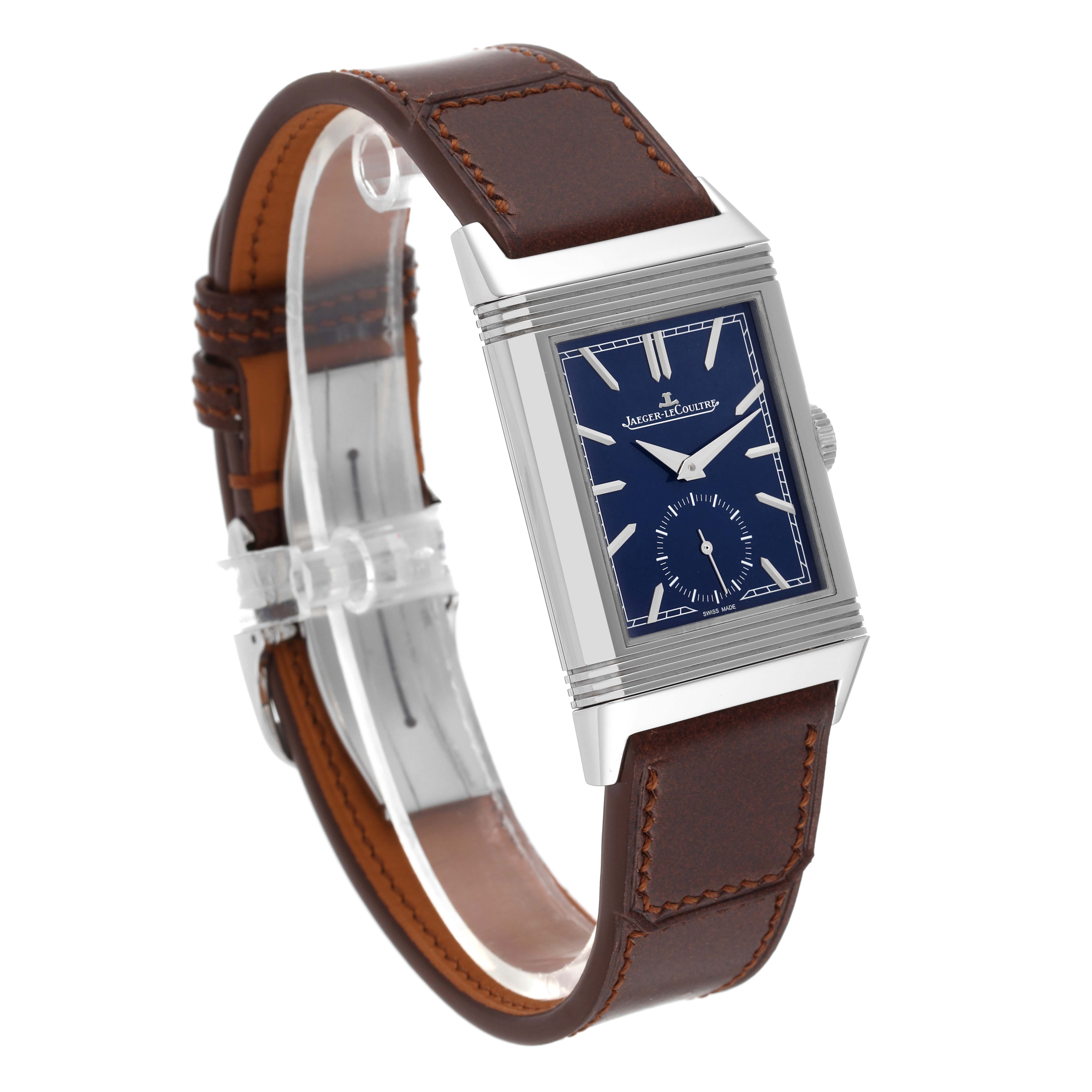 The image shows a Jaeger-LeCoultre Reverso watch at a three-quarter angle, highlighting its blue dial, rectangular case, and brown leather strap.