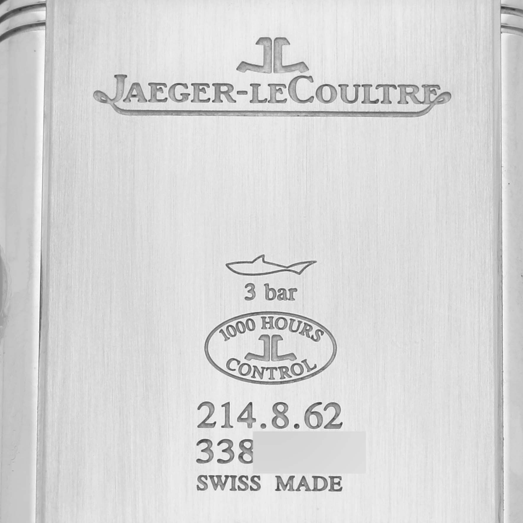 The image shows the back casing of a Jaeger-LeCoultre Reverso watch, displaying model information, water resistance, and certification details.