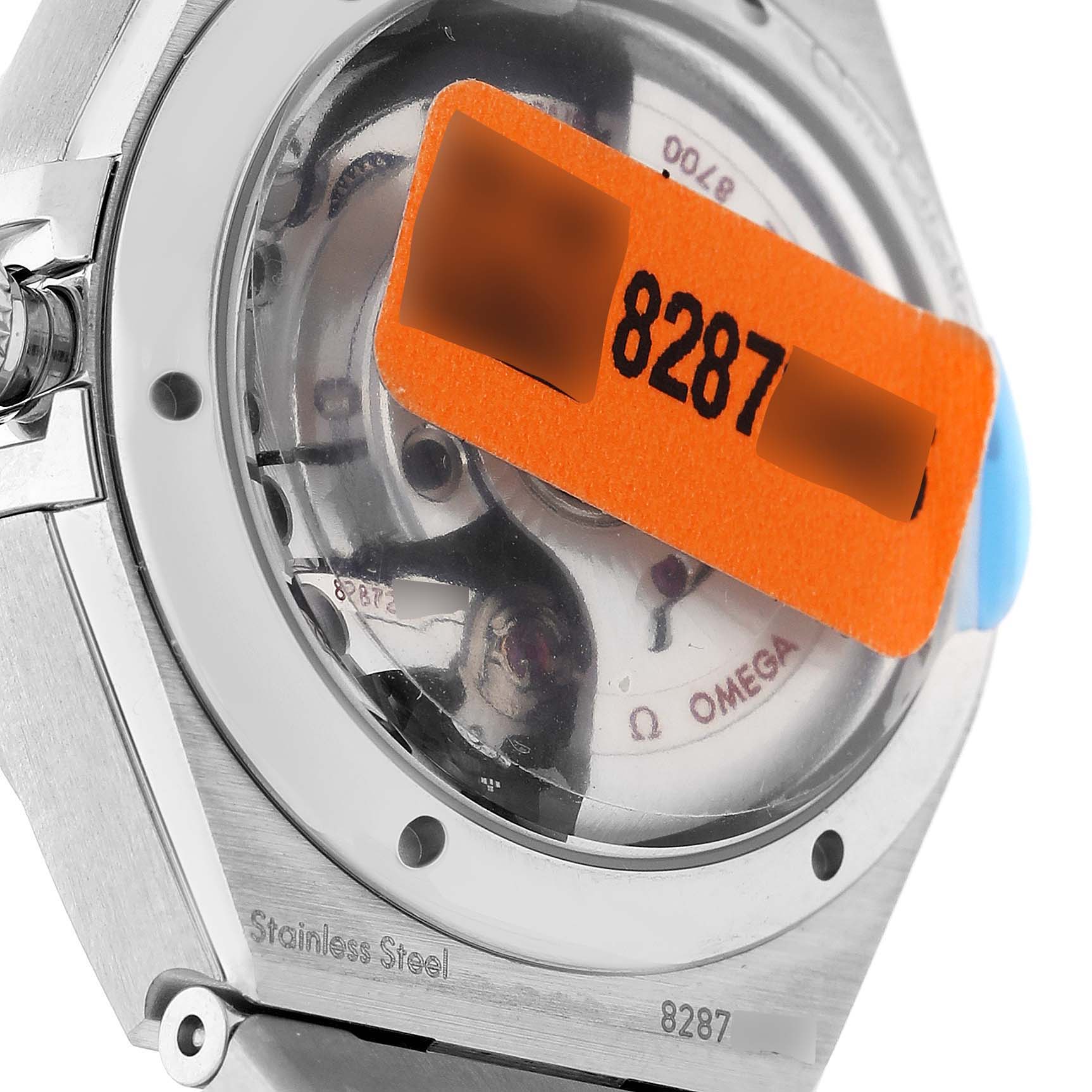 The image shows the case back and part of the movement of an Omega 131.15.29.20.53.001 Women's Stainless Steel Blue Dial 131.15.29.20.53.001 Women's Stainless Steel Blue Dial Constellation Steel Diamond Ladies Watch 131.15.29.20.53.001 Unworn model.