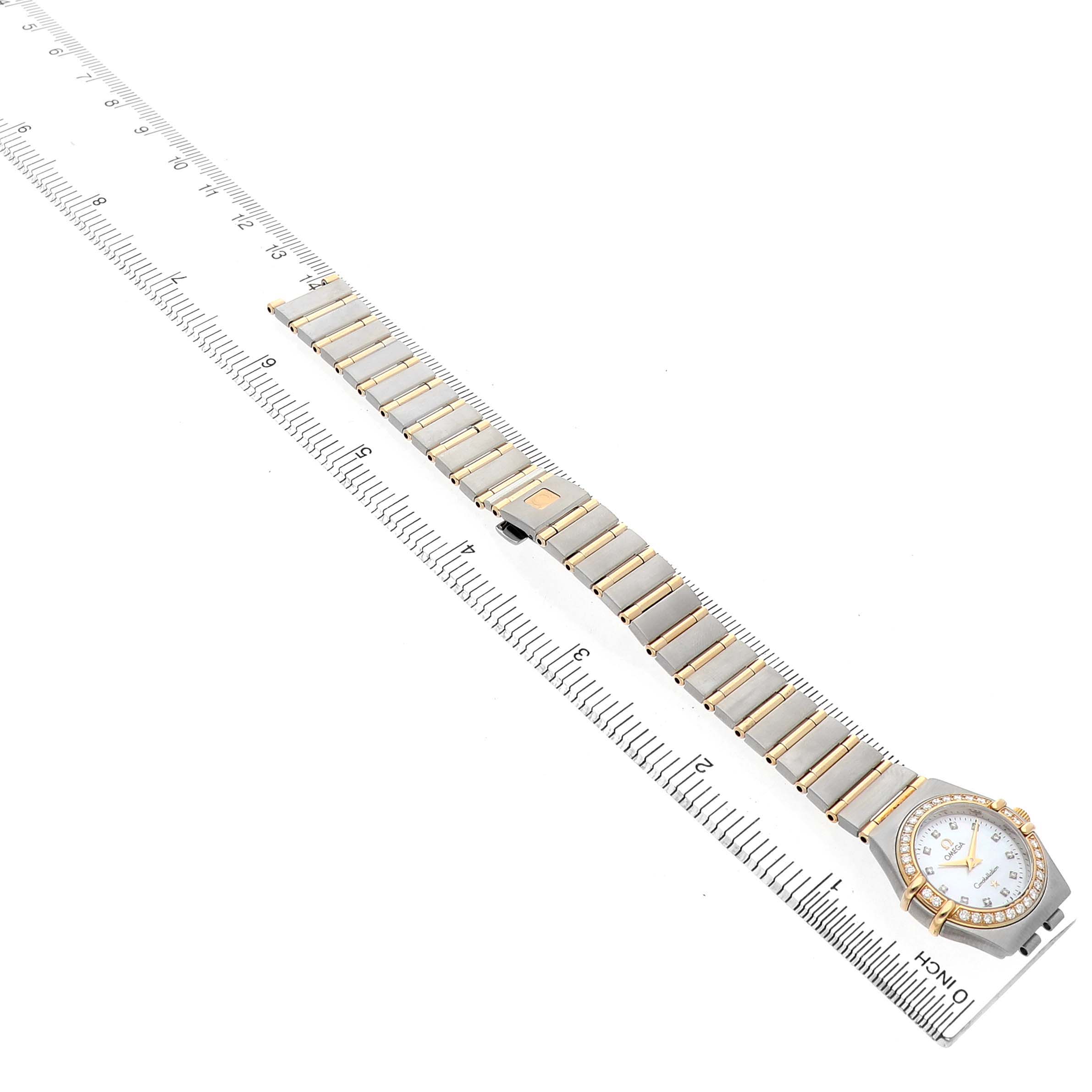 The Omega 1365.75.00 Women's Steel and Gold (two tone) Mother of Pearl Dial Constellation watch is shown from a top-down angle, highlighting the full bracelet and watch face alongside a ruler.