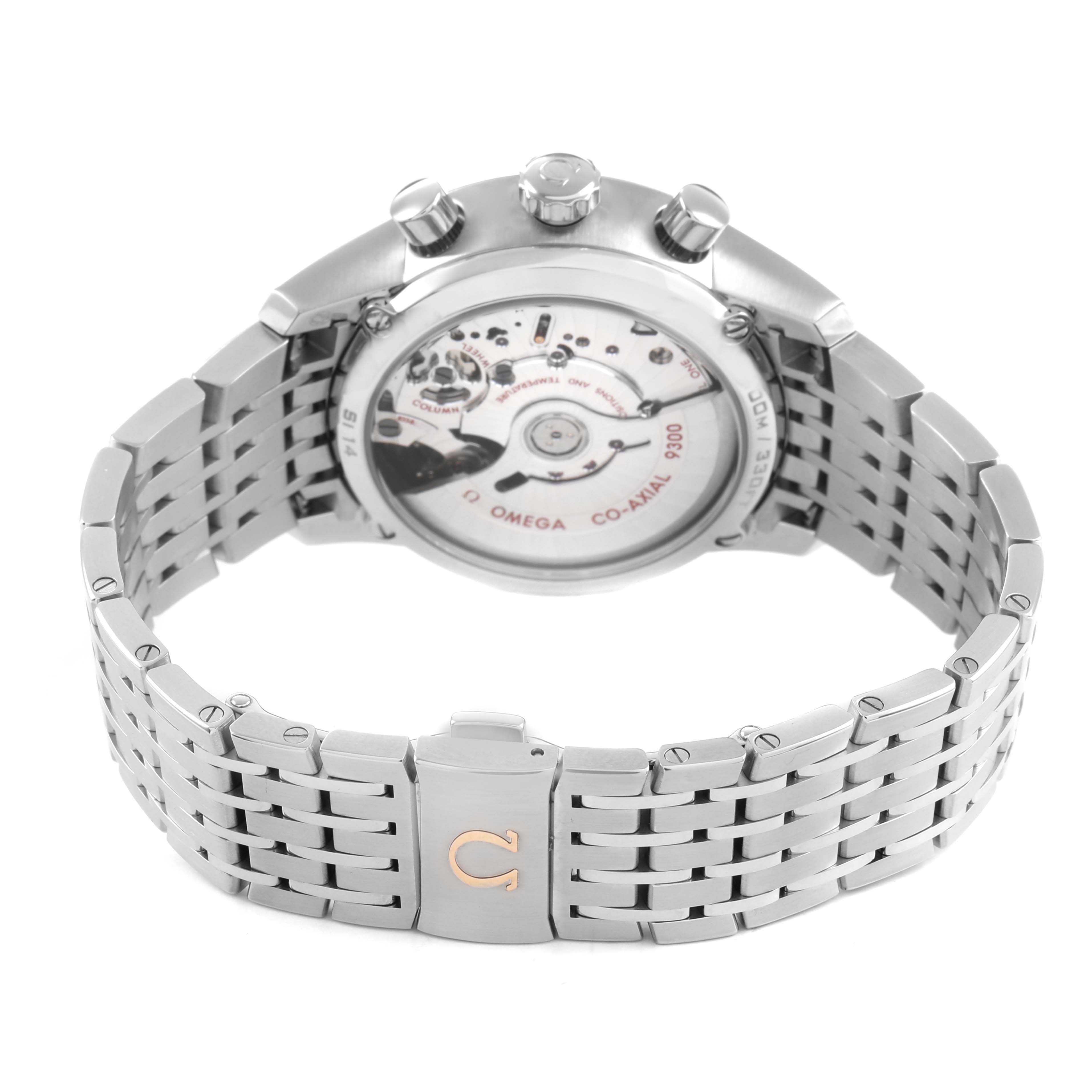 The image shows the Omega De Ville 431.10.42.51.02.001 Men's Stainless Steel Silver Dial watch from the back, highlighting the movement and stainless steel bracelet.