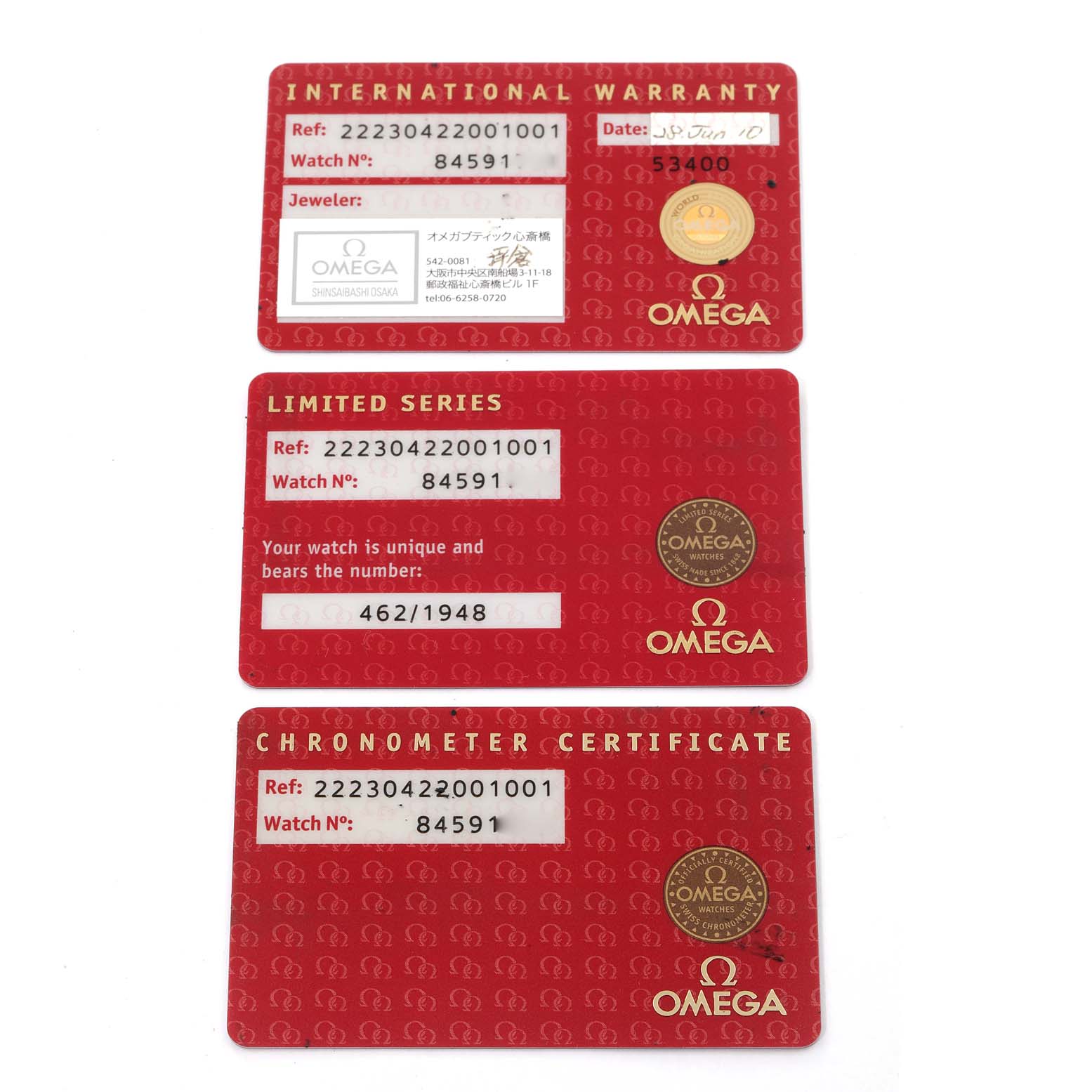 The image shows three red Omega cards for the Planet Ocean model: International Warranty, Limited Series, and Chronometer Certificate.