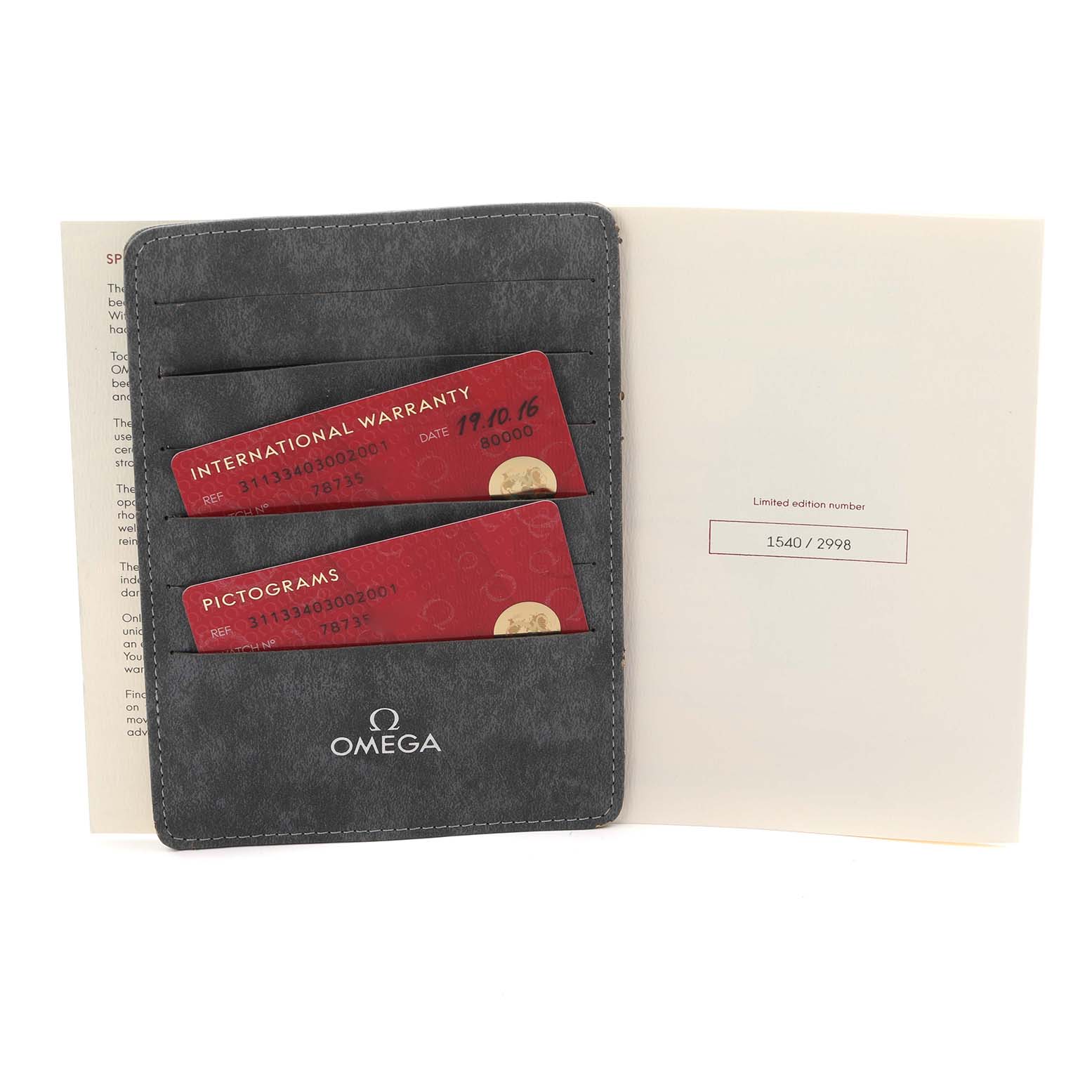 The image shows the Omega Speedmaster 311.33.40.30.02.001 Men
s Stainless Steel Silver Dial 311.33.40.30.02.001 Men
s Stainless Steel Silver Dial model
s warranty and pictogram cards in a holder, along with a booklet.