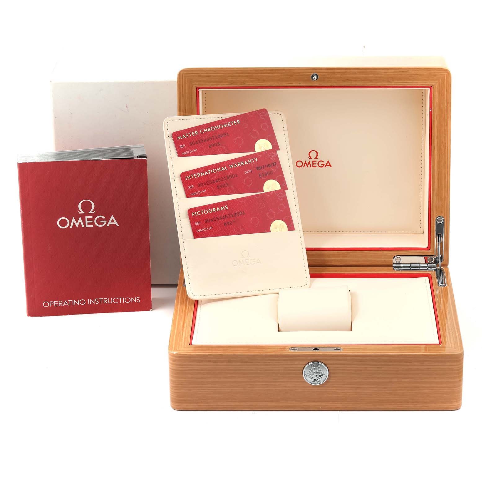 The image shows the accessories for the Omega Speedmaster 304.23.44.52.13.001 Men's Stainless Steel Brown Dial 304.23.44.52.13.001 Men's Stainless Steel Brown Dial watch, including the presentation box, operating instructions, and warranty cards.