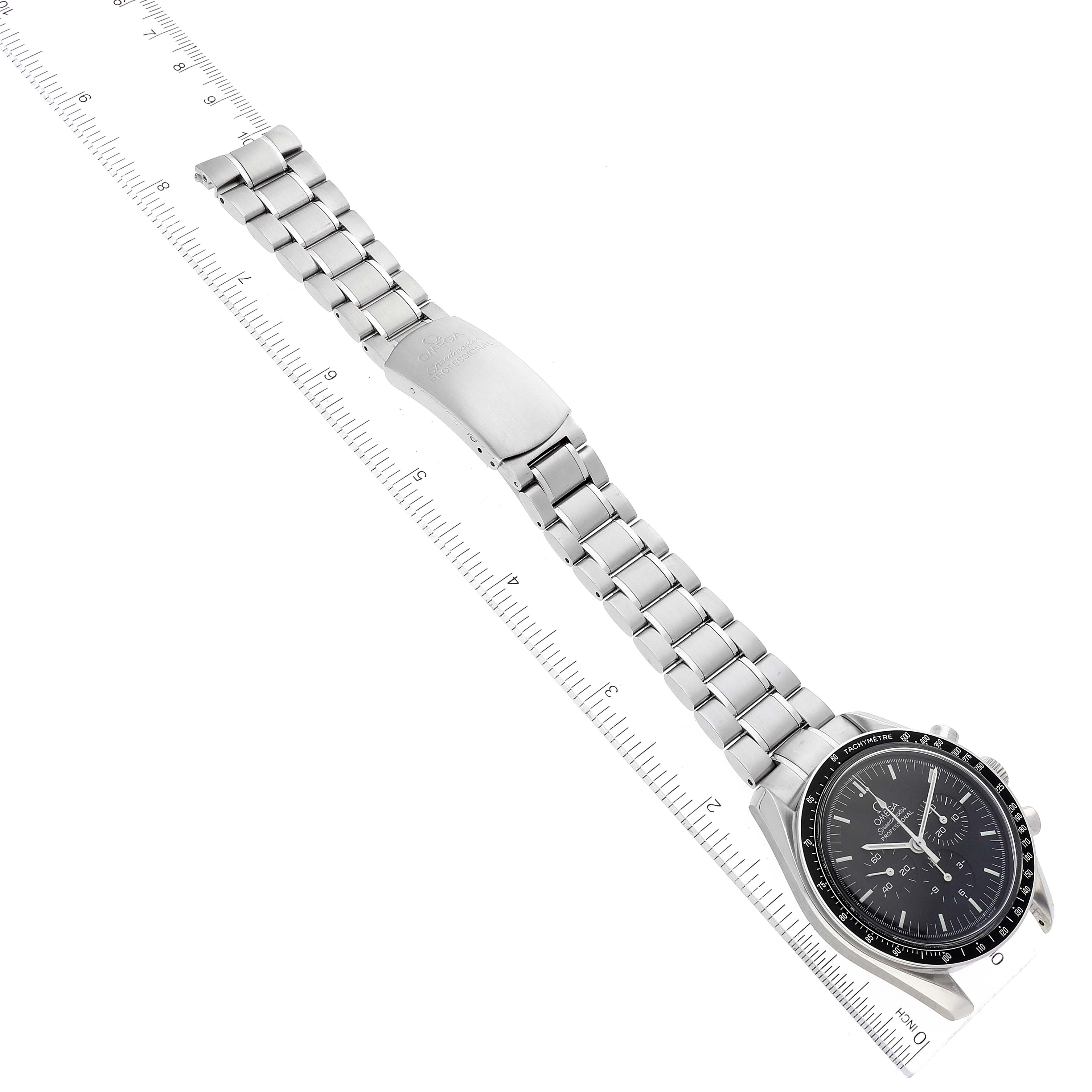 The Omega Speedmaster 3572.50.00 Men
s Stainless Steel Black Dial 3572.50.00 Men
s Stainless Steel Black Dial watch is shown flat, highlighting the dial, bezel, and full metal bracelet against a measuring ruler.