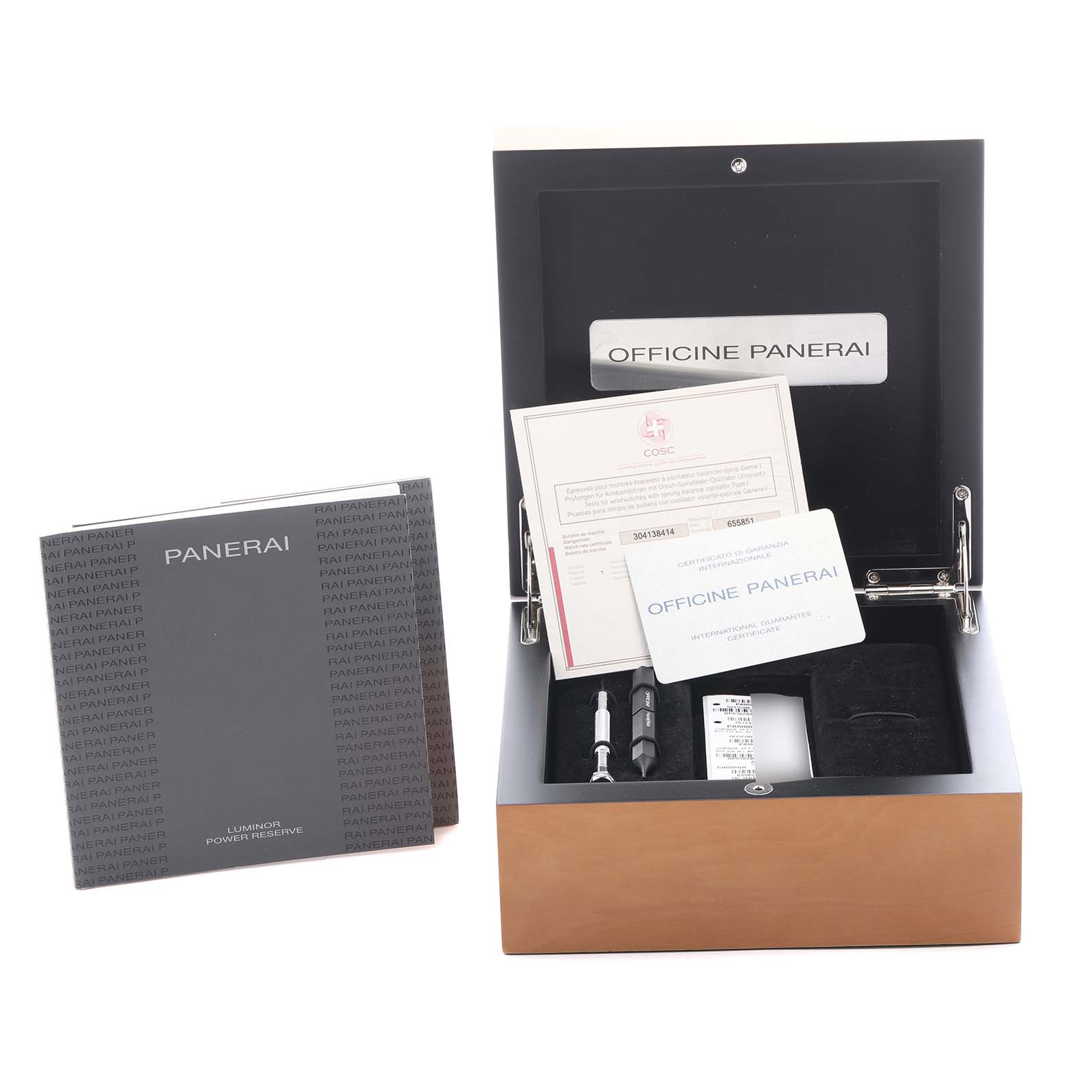 The image shows a Luminor model by Panerai with its box, documents, and tools, all viewed from above.