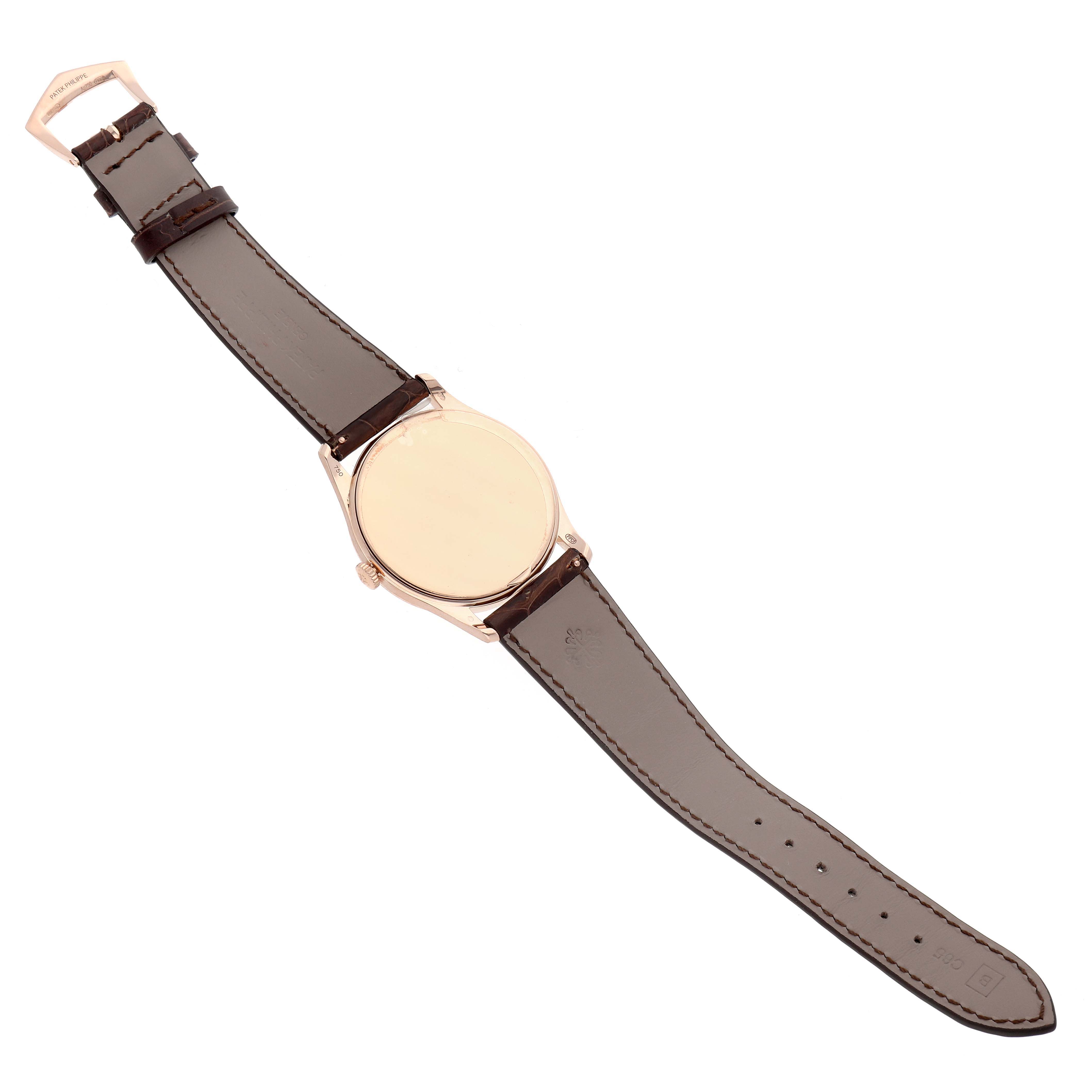 The image shows the back view of a Patek Philippe Calatrava 5196R Men's Rose Gold Silver Dial watch, highlighting the leather strap, buckle, and case back.