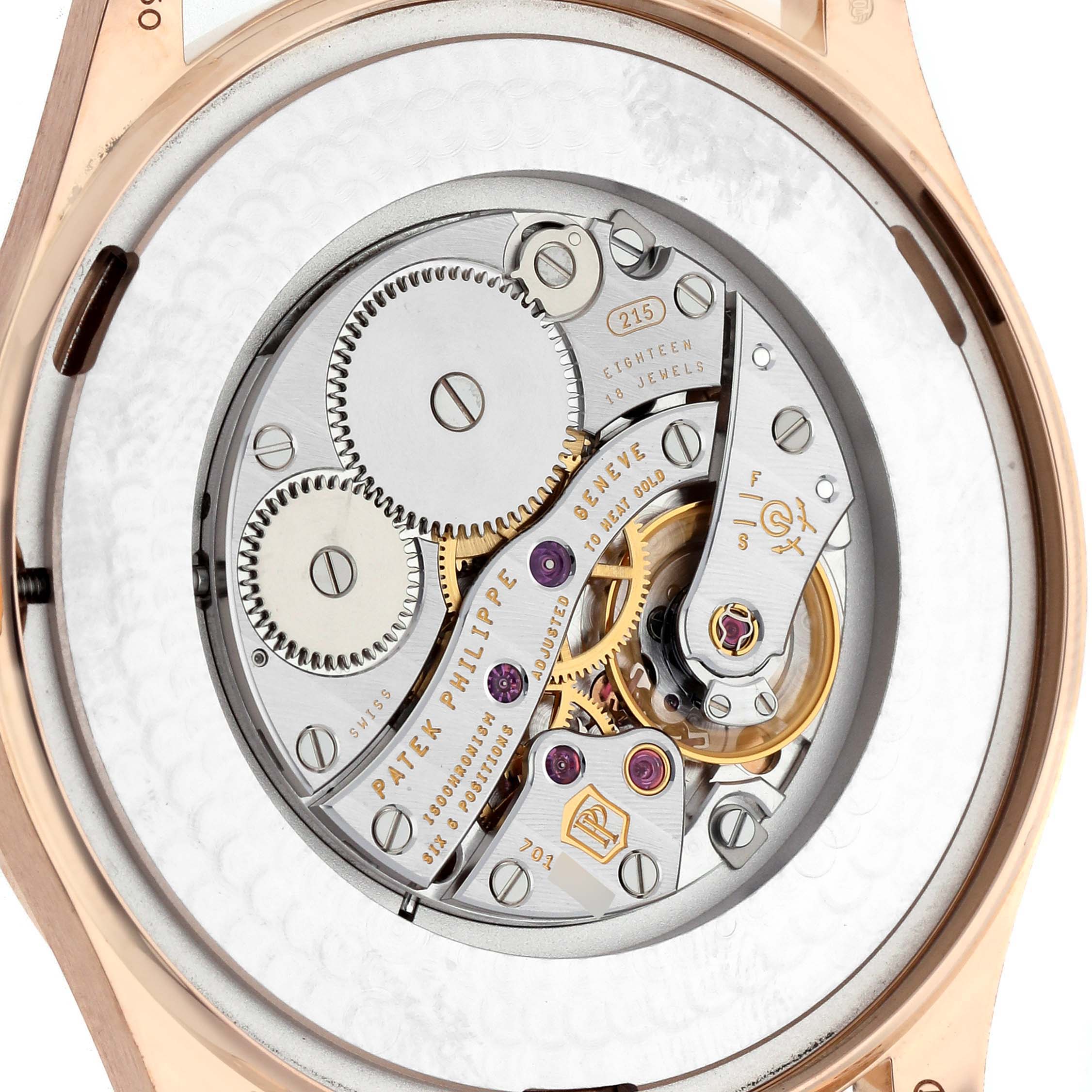 The image shows the movement of a Patek Philippe Calatrava 5196R Men's Rose Gold Silver Dial watch from the back, highlighting gears and jewels.