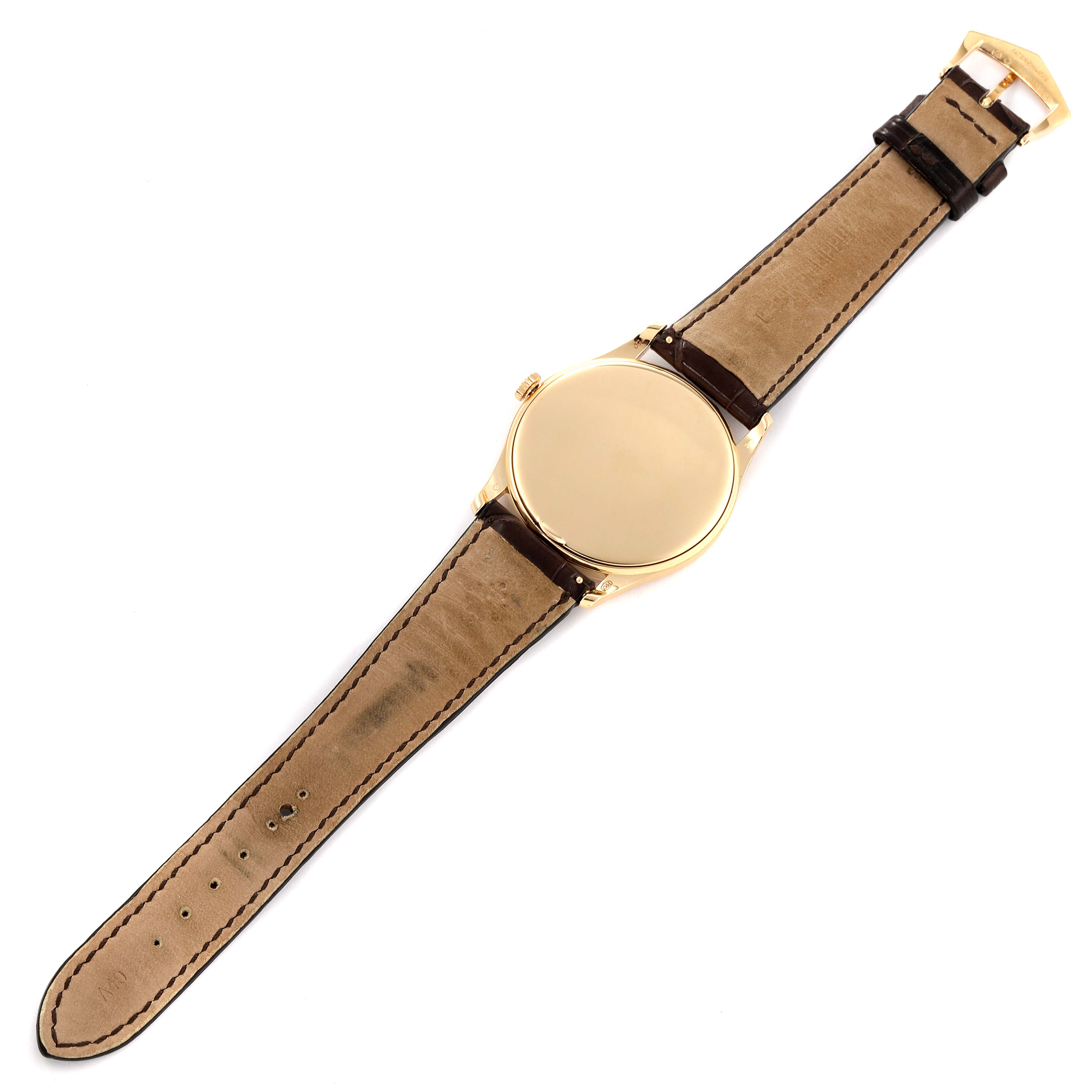 This image shows the back of a Patek Philippe Calatrava 5196J Men's Yellow Gold Silver Dial 5196J Men's Yellow Gold Silver Dial watch with its leather strap fully extended.