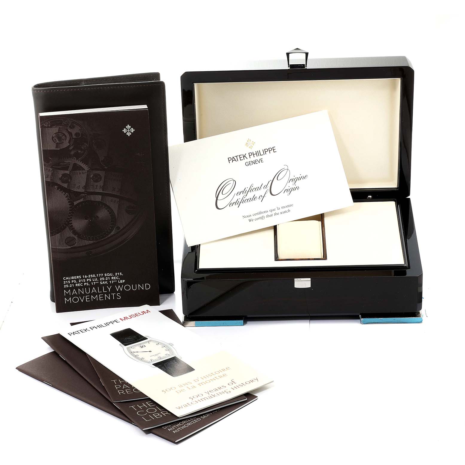 The image shows packaging and documentation for a Patek Philippe Calatrava 5196J Men's Yellow Gold Silver Dial 5196J Men's Yellow Gold Silver Dial watch, including a presentation box, manuals, and certificates.