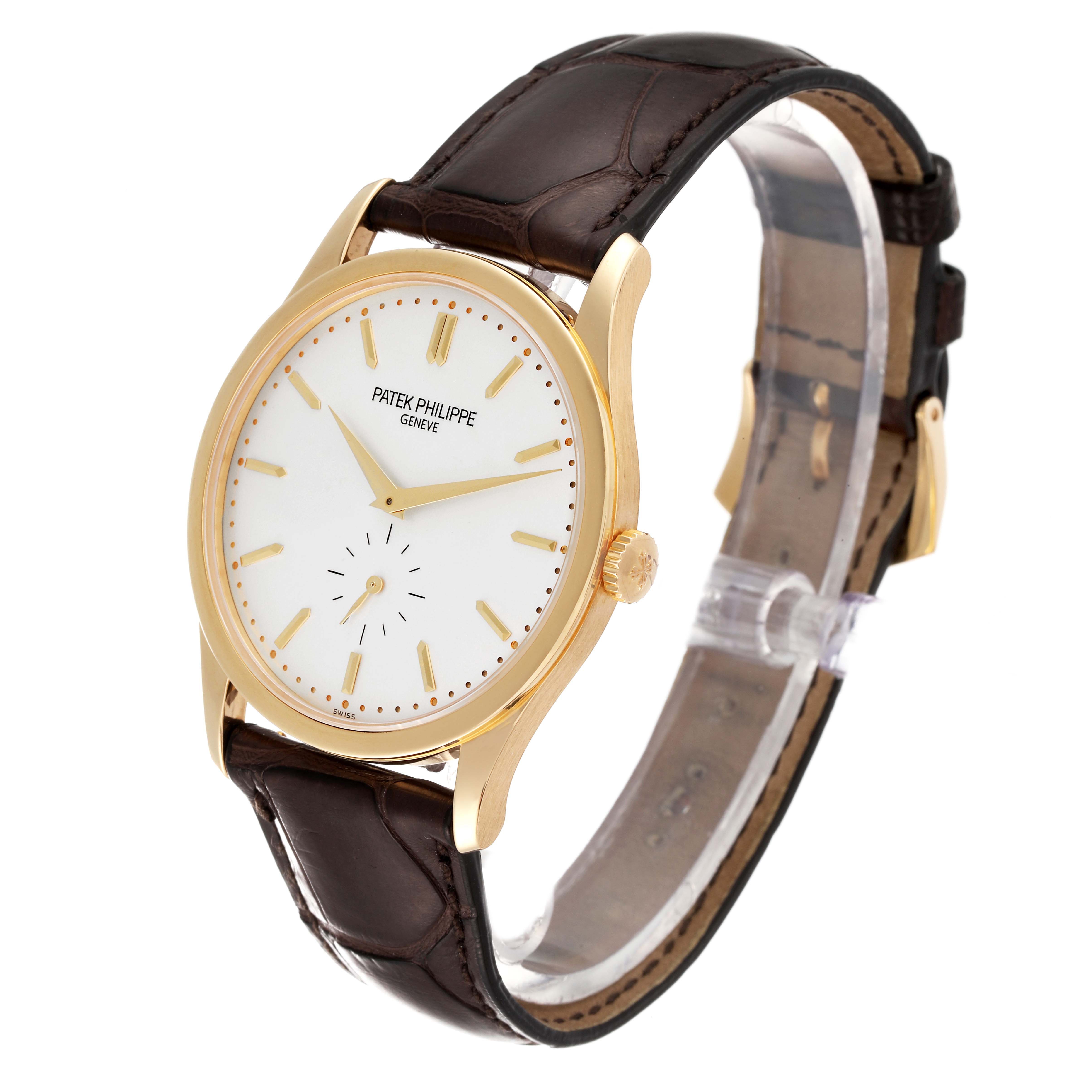 This image shows a Patek Philippe Calatrava 5196J Men's Yellow Gold Silver Dial 5196J Men's Yellow Gold Silver Dial watch angled slightly from the front, displaying its dial, crown, and brown leather strap.