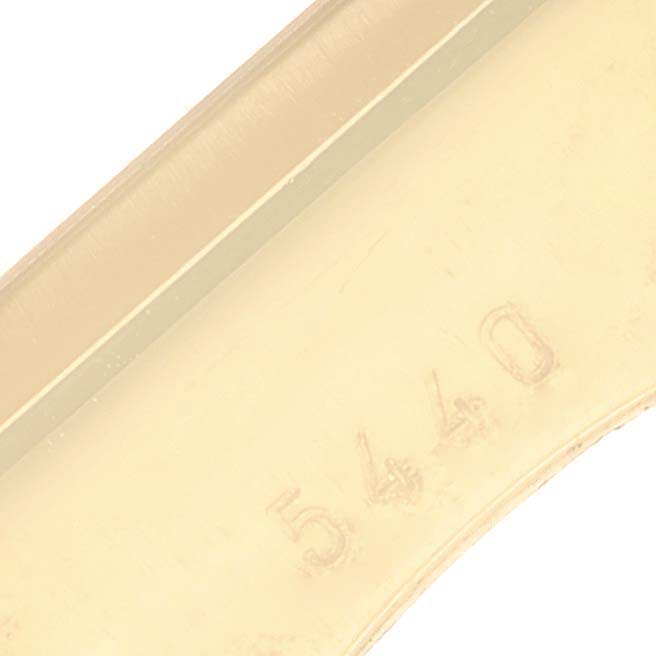 This image shows a close-up angle of a Rolex Cellini 5440/8 Men
s Yellow Gold Champagne Dial 5440/8 Men
s Yellow Gold Champagne Dial watch focusing on the band with a partial view of the number "5440."