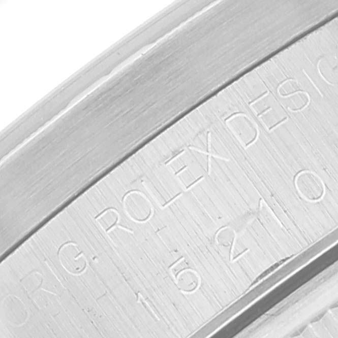 This close-up view shows the engraved serial number and design text on the case of a Rolex Date 15210 Men's Stainless Steel Black Dial 15210 Men's Stainless Steel Black Dial model watch.