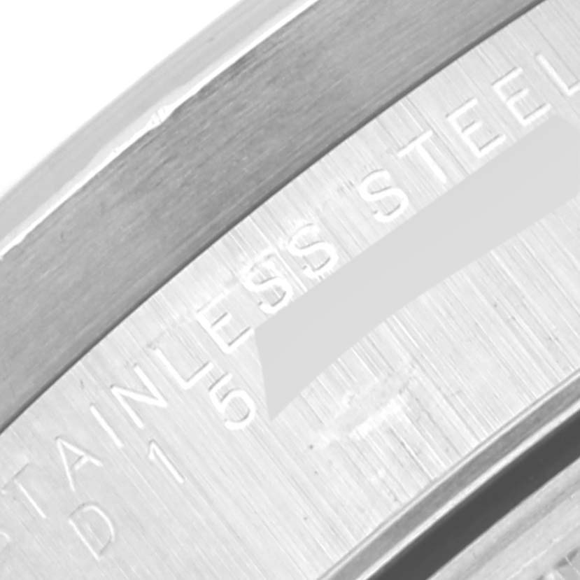 This close-up image shows the stainless steel casing and part of the engraved serial number of a Rolex Date 15210 Men's Stainless Steel Blue Dial 15210 Men's Stainless Steel Blue Dial model.
