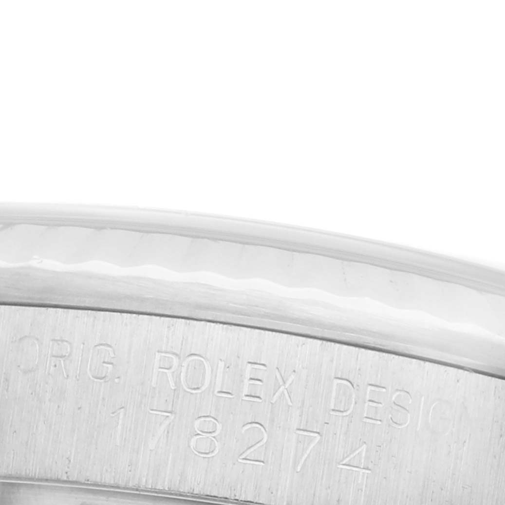 The image shows a close-up of the edge and engraved markings on the bezel of a Rolex Mid-Size 178274 Women's Stainless Steel Black Dial 178274 Women's Stainless Steel Black Dial watch.