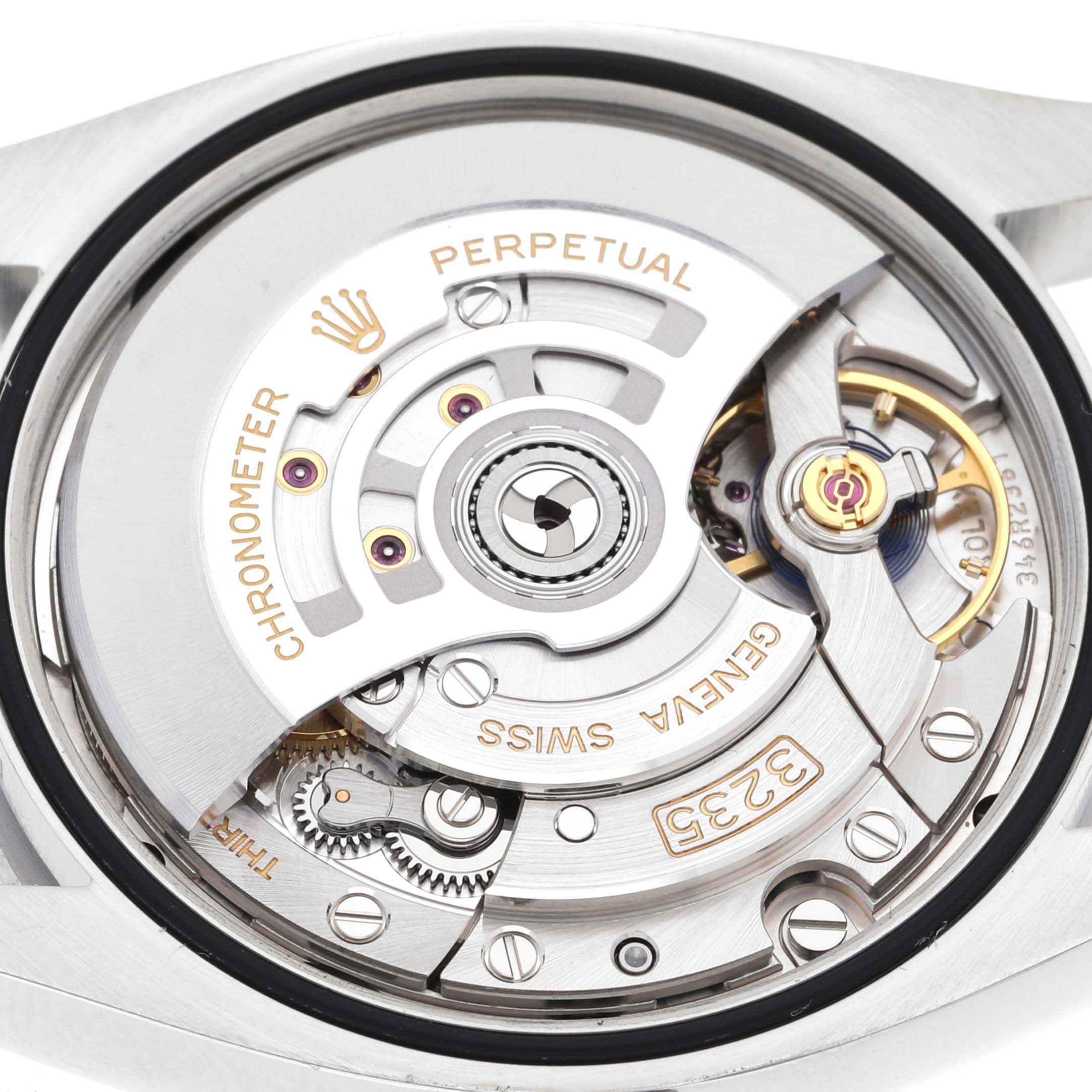 This image shows the internal movement mechanism of a Rolex Datejust 126200 Men's Stainless Steel Grey Dial 126200 Men's Stainless Steel Grey Dial watch, including gears and engraved details.