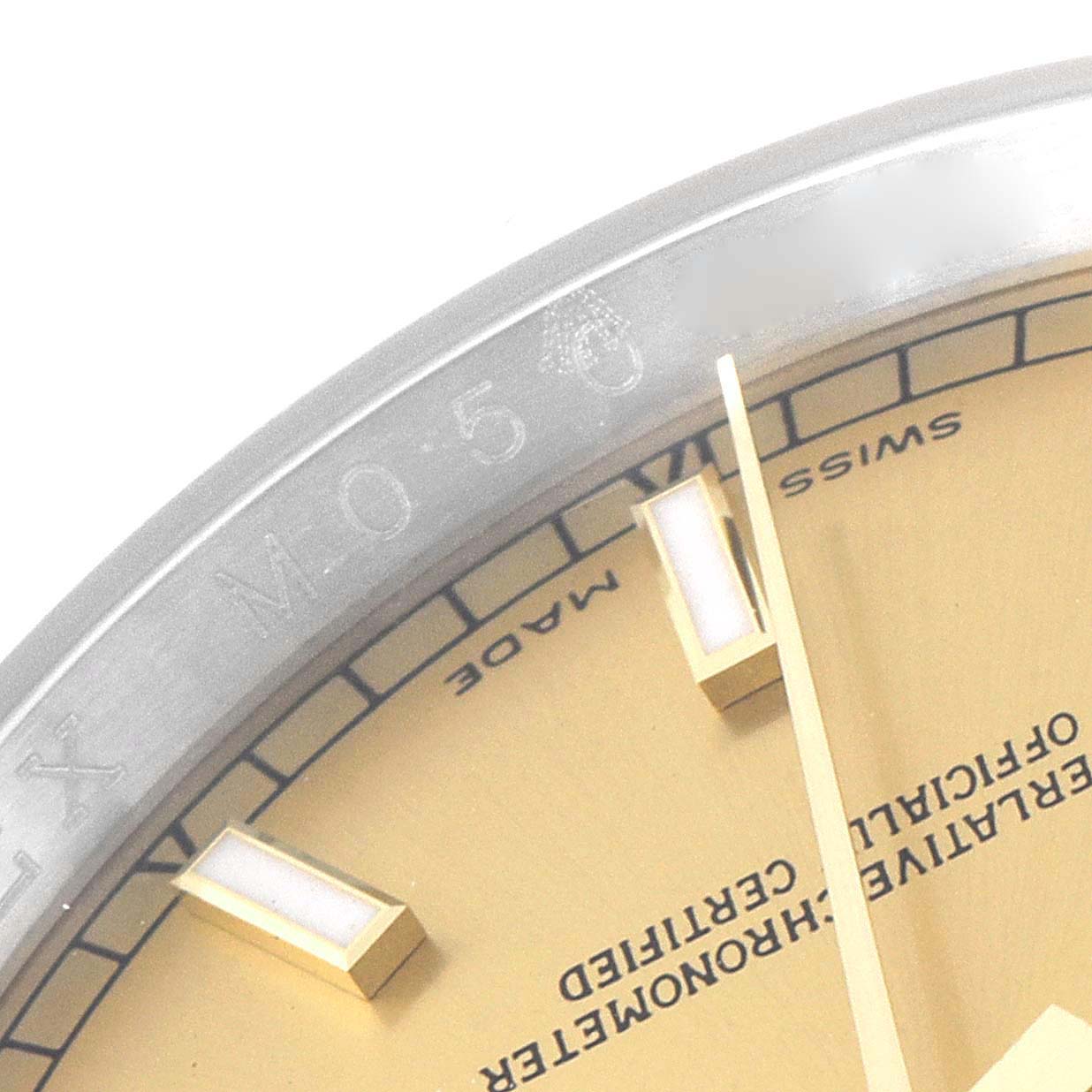 This image shows the edge of the dial and bezel of a Rolex Datejust 116233 Men's Steel and Gold (two tone) Champagne Dial 116233 Men's Steel and Gold (two tone) Champagne Dial watch, highlighting the text and hour markers.