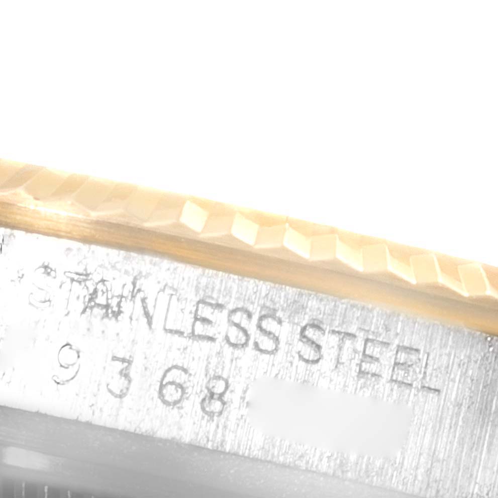 The image shows a close-up of the case edge with a portion of the bezel and "Stainless Steel" engraving on a Vintage Collection Rolex watch.