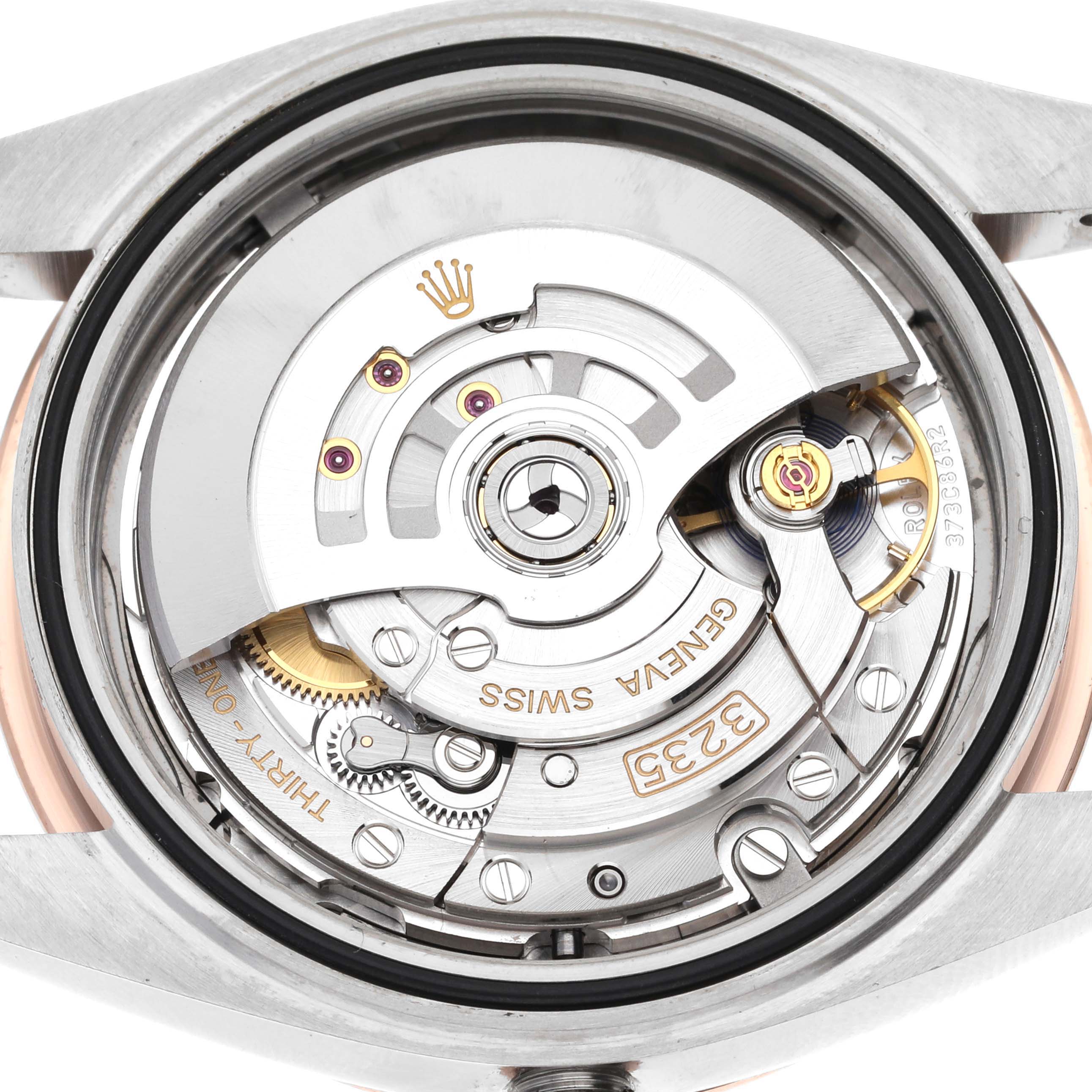 The image shows the movement of a Rolex Datejust 41 126301 Men's Steel and Gold (two tone) Grey Dial 126301 Men's Steel and Gold (two tone) Grey Dial watch from a back angle, highlighting the intricate mechanics.