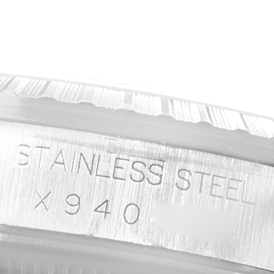 This image shows a close-up of the side of the stainless steel case on a Rolex Datejust 16220 Men
s Stainless Steel Grey Dial 16220 Men
s Stainless Steel Grey Dial watch, revealing part of its serial number.