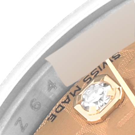 This close-up of a Rolex Datejust 179173 Women's Steel and Gold (two tone) Champagne Dial 179173 Women's Steel and Gold (two tone) Champagne Dial watch shows the dial, bezel edge, and a diamond hour marker with the words "SWISS MADE."