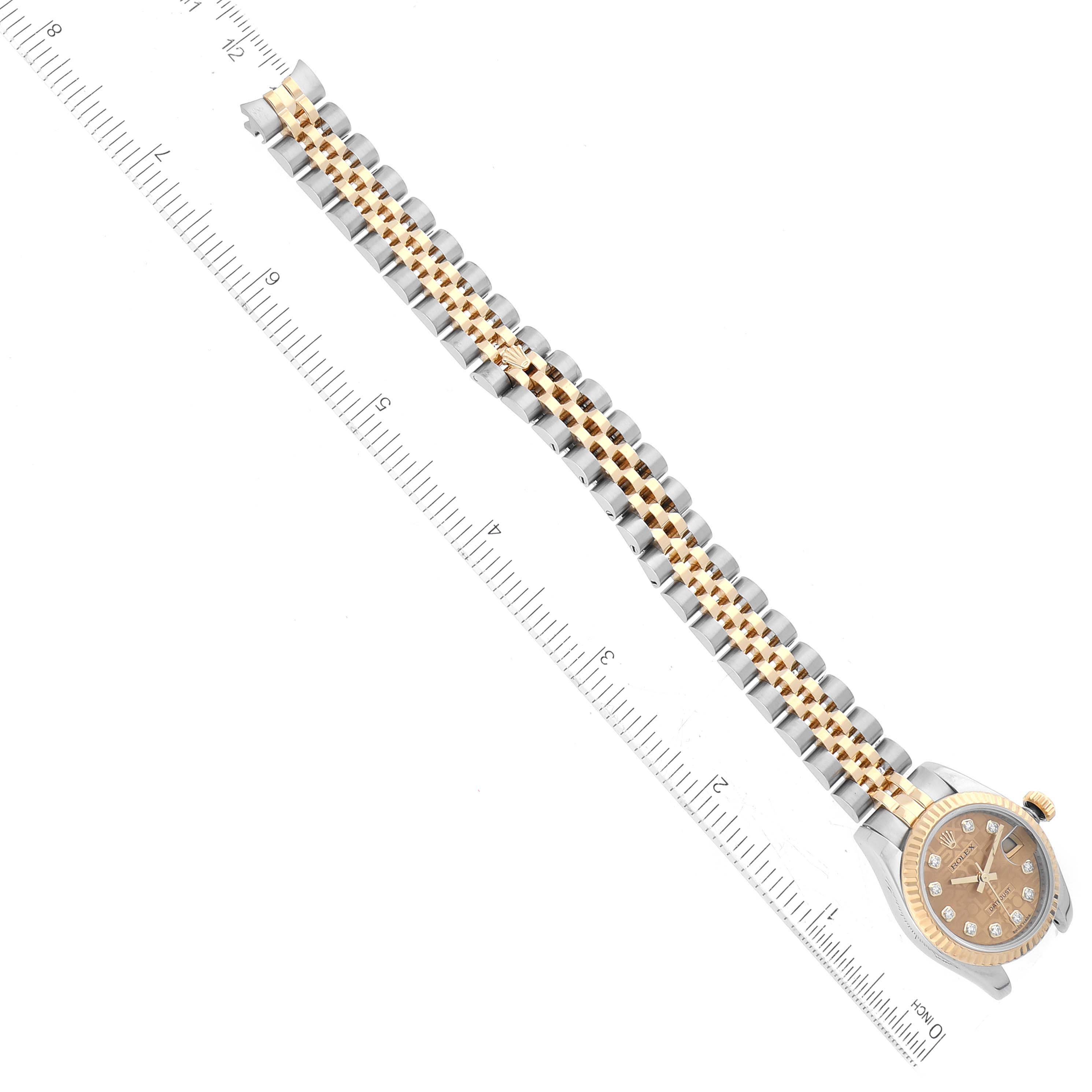 The image shows the Rolex Datejust 179173 Women's Steel and Gold (two tone) Champagne Dial 179173 Women's Steel and Gold (two tone) Champagne Dial model watch, including its dial and bracelet, alongside a measuring scale.