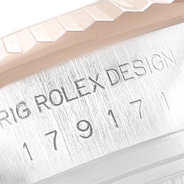 The angle shows a close-up of the serial number and part of the fluted bezel of the Rolex Datejust 179171 Women's Steel and Gold (two tone) Pink Dial 179171 Women's Steel and Gold (two tone) Pink Dial.