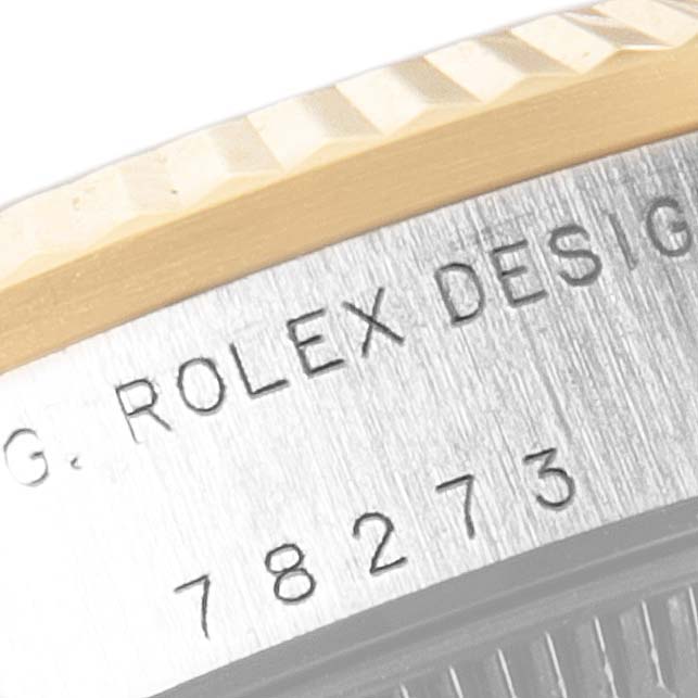 The image shows a close-up of the Rolex Mid-Size 78273 Women's Steel and Gold (two tone) Grey Dial 78273 Women's Steel and Gold (two tone) Grey Dial model's case, highlighting the bezel and engravings.